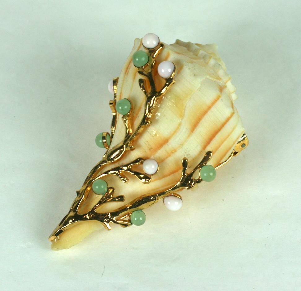 Jeweled clip made from a genuine shell decorated with gilt bronze seaweed findings and poured glass cabochons in pale jade and pink coral, hand made in the Parisian studios of Mark Walsh Leslie Chin, MWLC.
Double prong clip closure for stability.