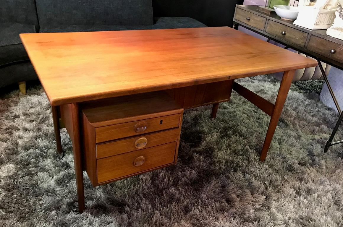 A stunning combination in beautiful vintage condition. Designed by Kai Kristiansen and made by Povl Dinesen. Wonderfully crafted and designed (with three front drawers and two storage compartments at backside) from solid teak. This desk and chair