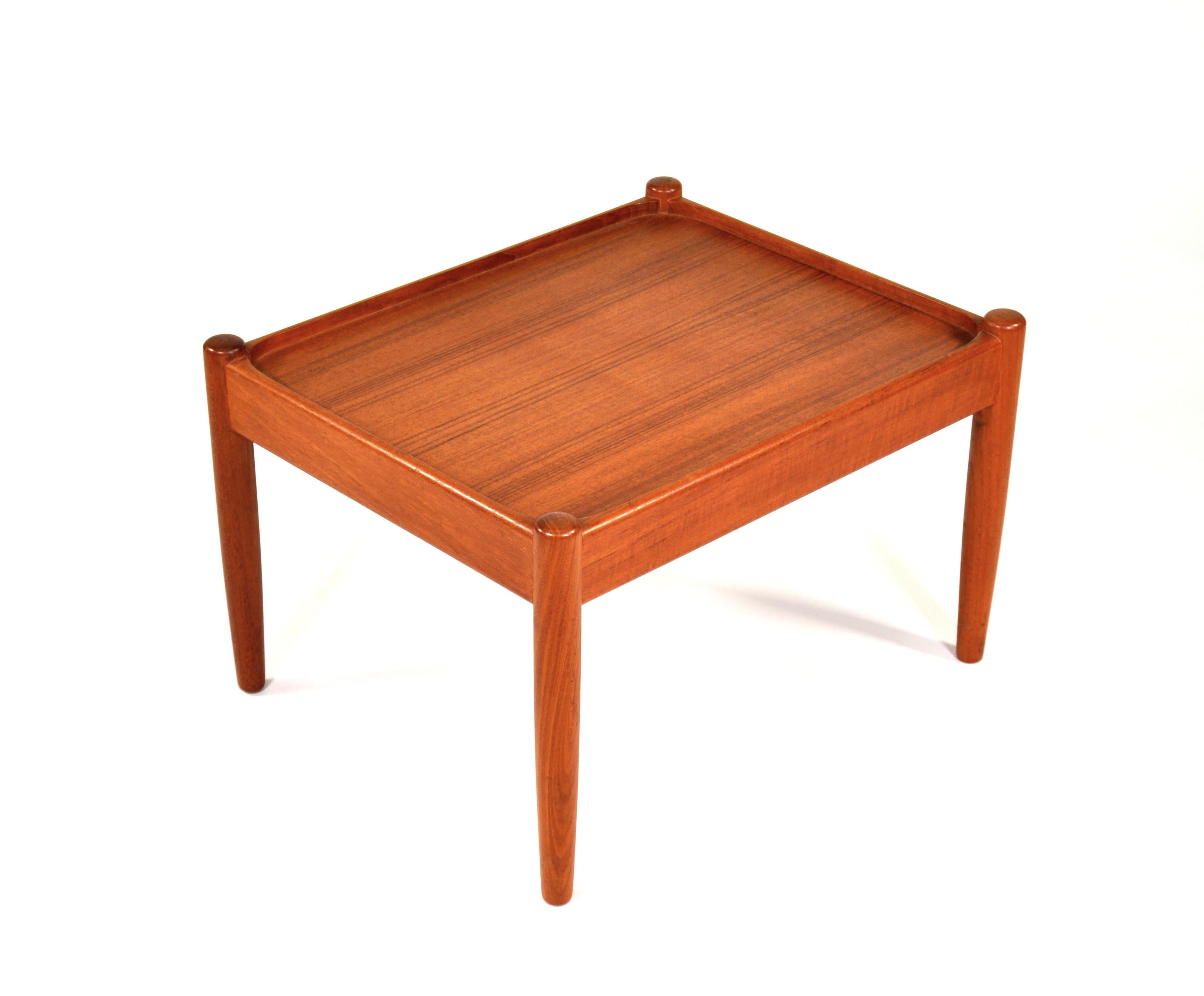 A vintage Danish mid-century teak end table by Poul Dinesen, dating from the 1960s. The occasional table has simple, clean lines, typical of Scandinavian Modern designs. Made in Denmark. Bears original label.