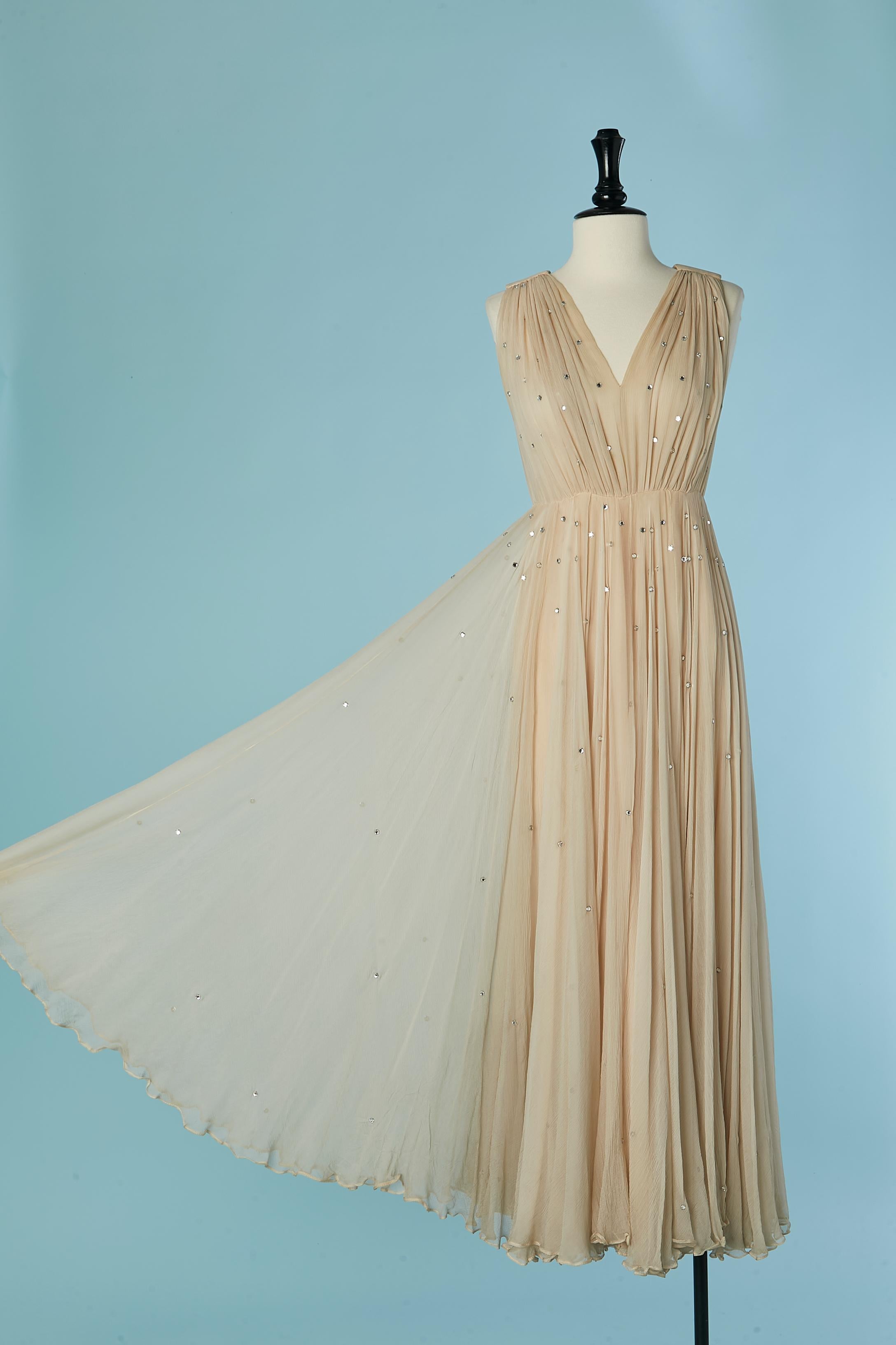 Powder beige silk chiffon evening dress with rhinestone embellishment. The top part is lightly see-through
Acetate or rayon lining. 
Zip and hook&eye closure on the middle back. 
SIZE XS 