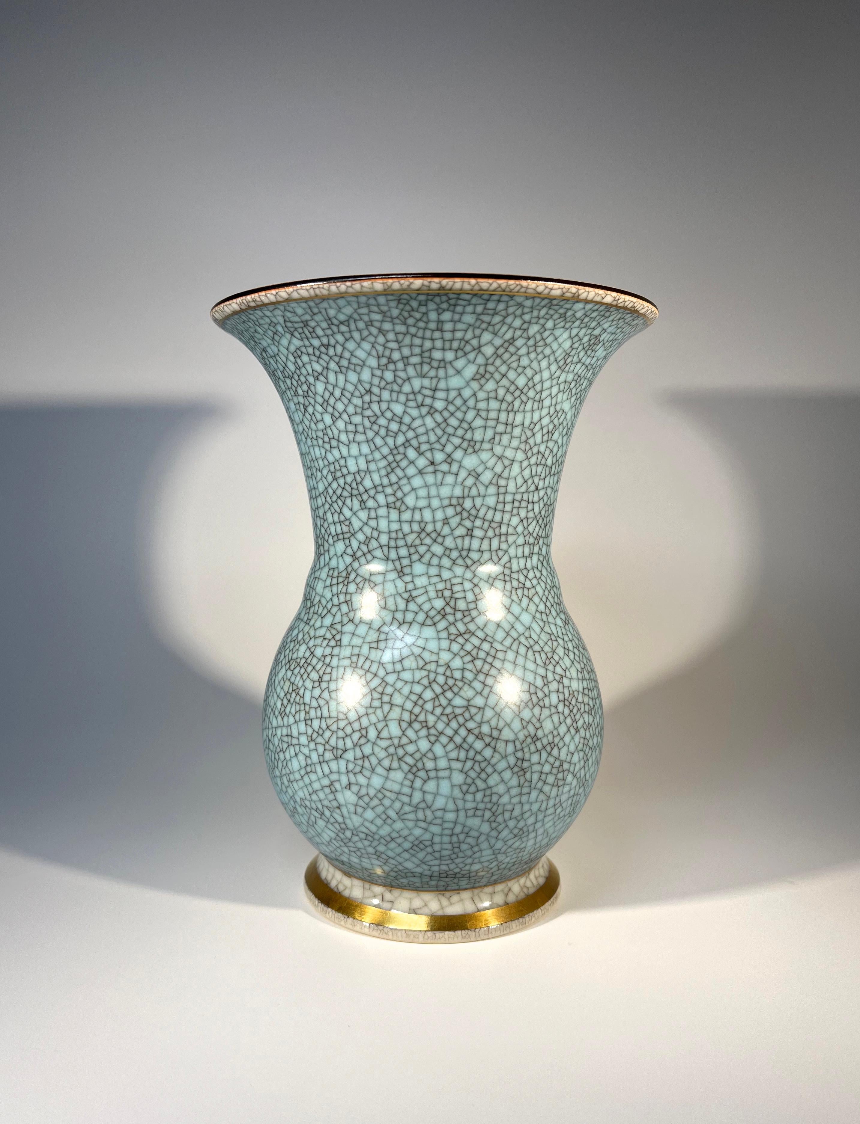 Powder blue Royal Copenhagen crackle glazed porcelain vase with gilded banding 
Notable, well defined dark crackle exterior
Designed by Thorkild Olsen
Circa 1954
Stamped and numbered 2491
Height 6.75 inch, Diameter 4.75 inch
In good condition
Wear