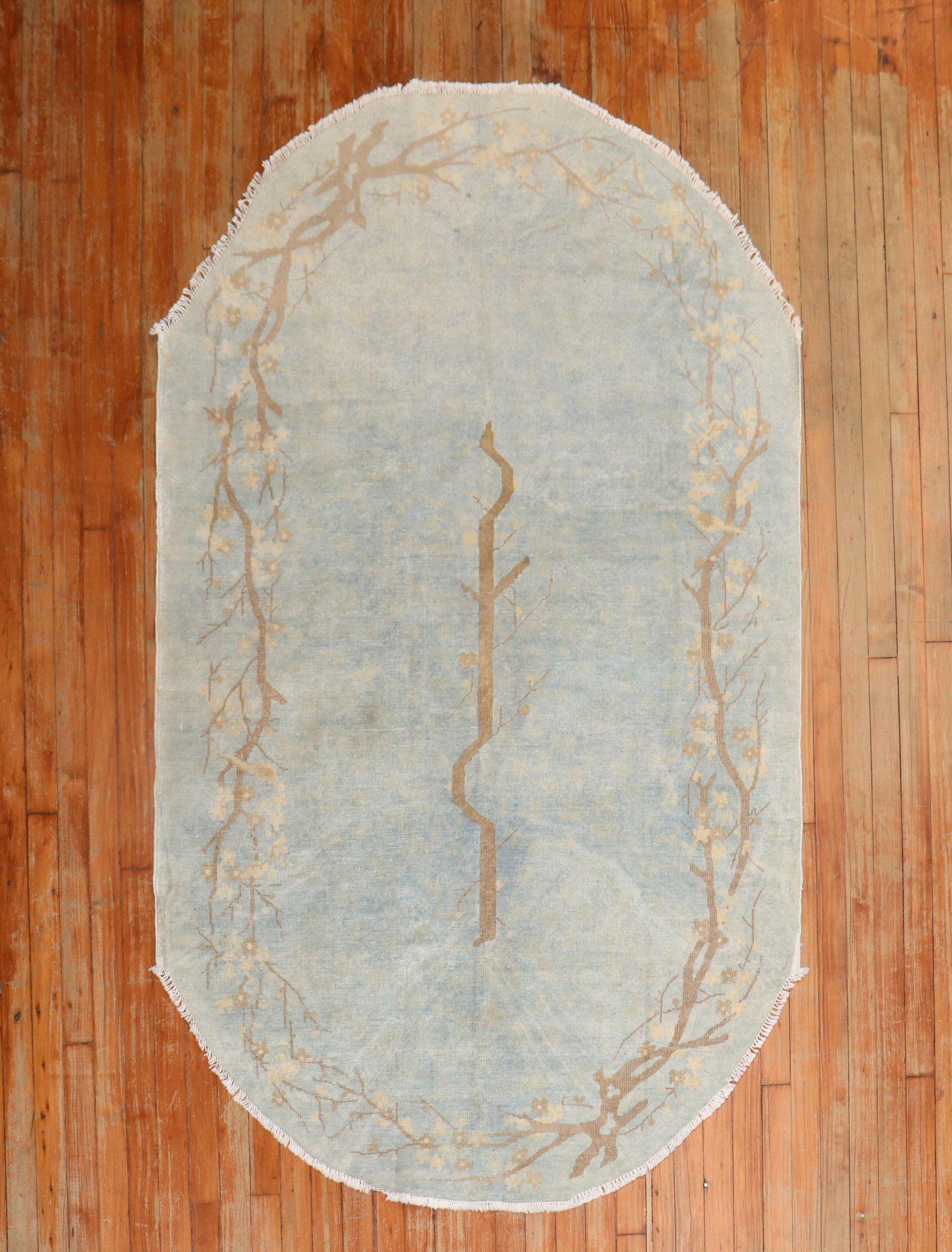 An oval-shaped worn early 20th century Chinese rug in powder blue.

Measures: 4' x 7'.

