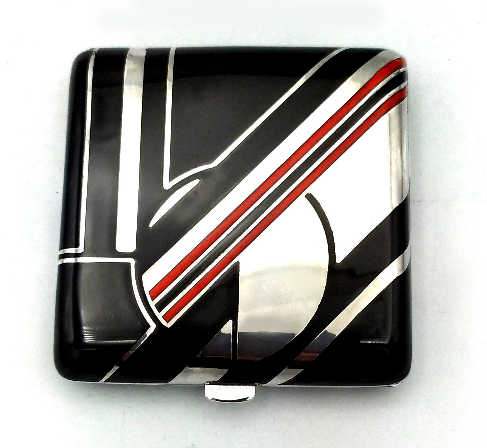 Powder case for handbag in 925/1000 sterling silver with black and red fired enamel. Opening with spring button. Ground mirror and retina inside. Measure cm. 7.3 x 7.3 x 1.5. Weight gr.250. Created in the Art Deco style for Cartier USA in the 1980s,