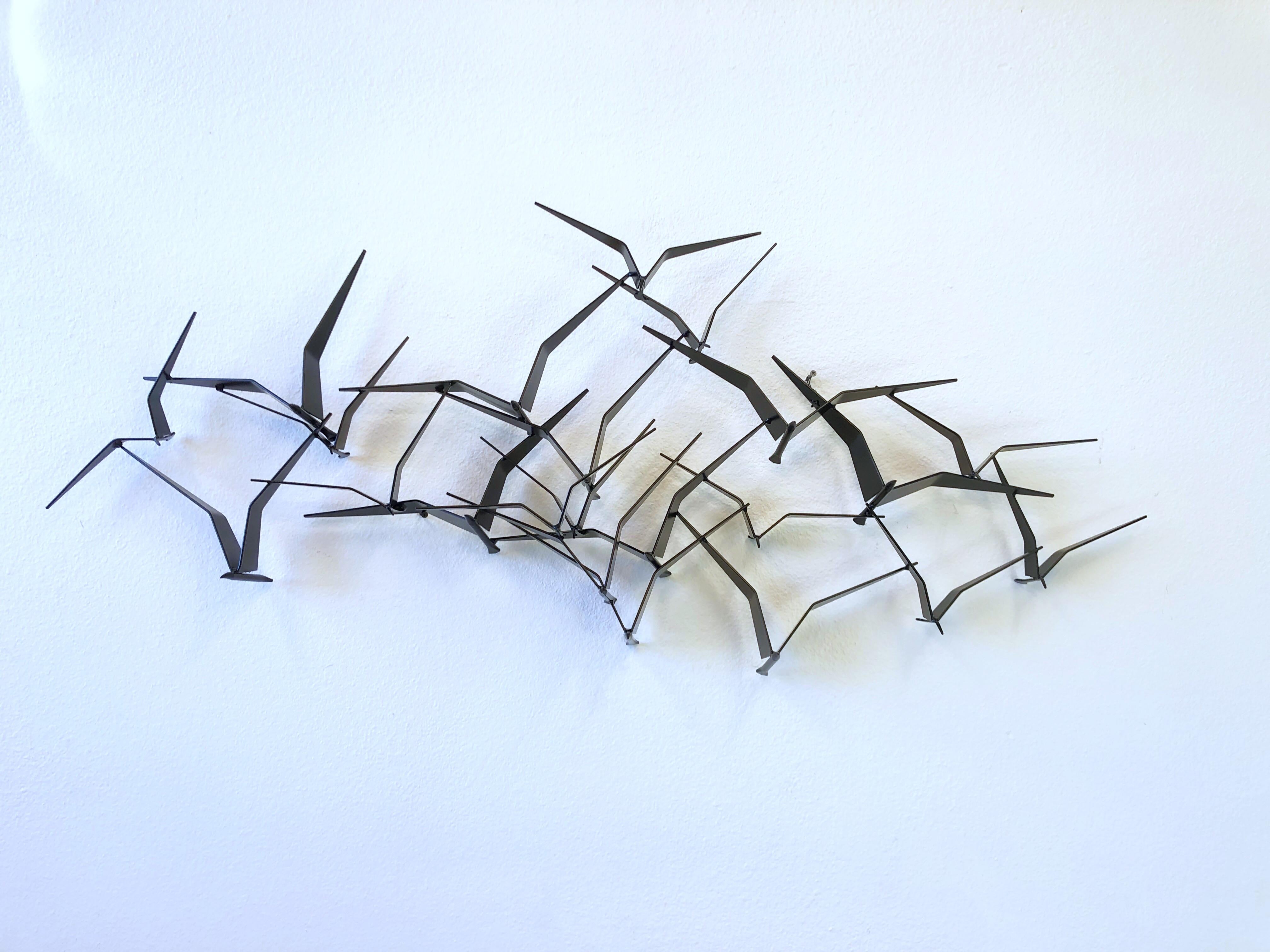 Iconic 1970’s flock of bird wall sculpture by Curtis Jeré. 
Newly black powder coated. 
This was hanging in a wall outdoor for many years, so the signature is gone. 

Measurements: 56” Wide, 24” High, 7.25” Deep at center.