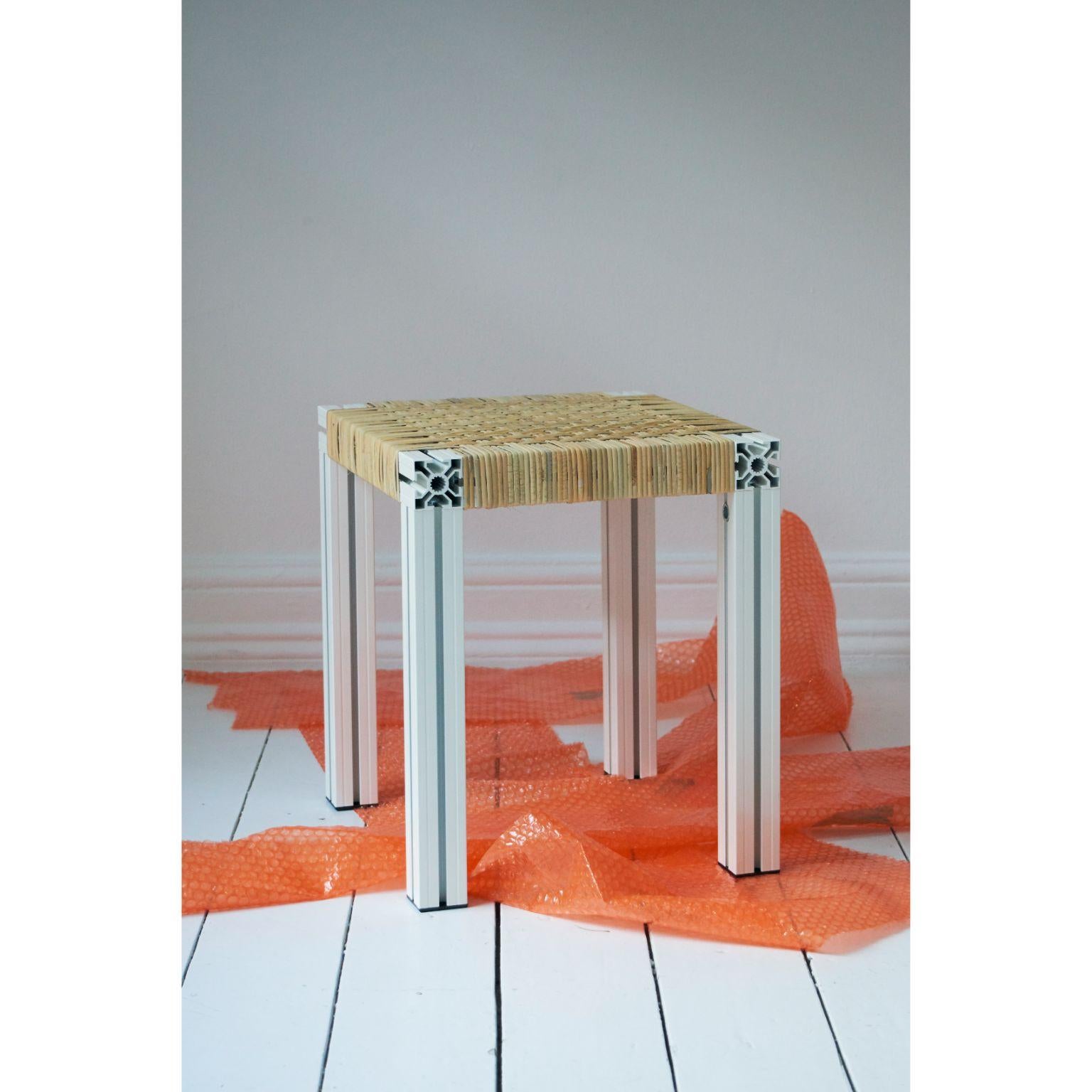Powder Coated white and cane wicker stool by Tino Seubert
Dimensions: D 43 x W 38 x H 45 cm.
Materials: Powder coated aluminum extrusions, cane weave.

Tino Seubert
When he first made his now signature wicker and aluminium stools and benches in