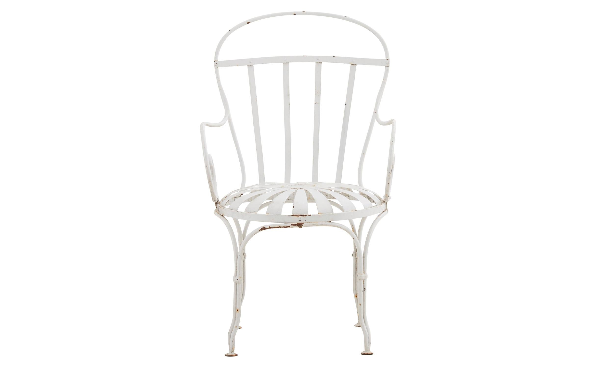 Our vintage Patio chair was crafted in America in the early 20th century. Made in the style of Francois Carre’s outdoor furniture, this metal garden chair features rolled arm rests and a sunburst seat, paired with a white powder coated finish. This