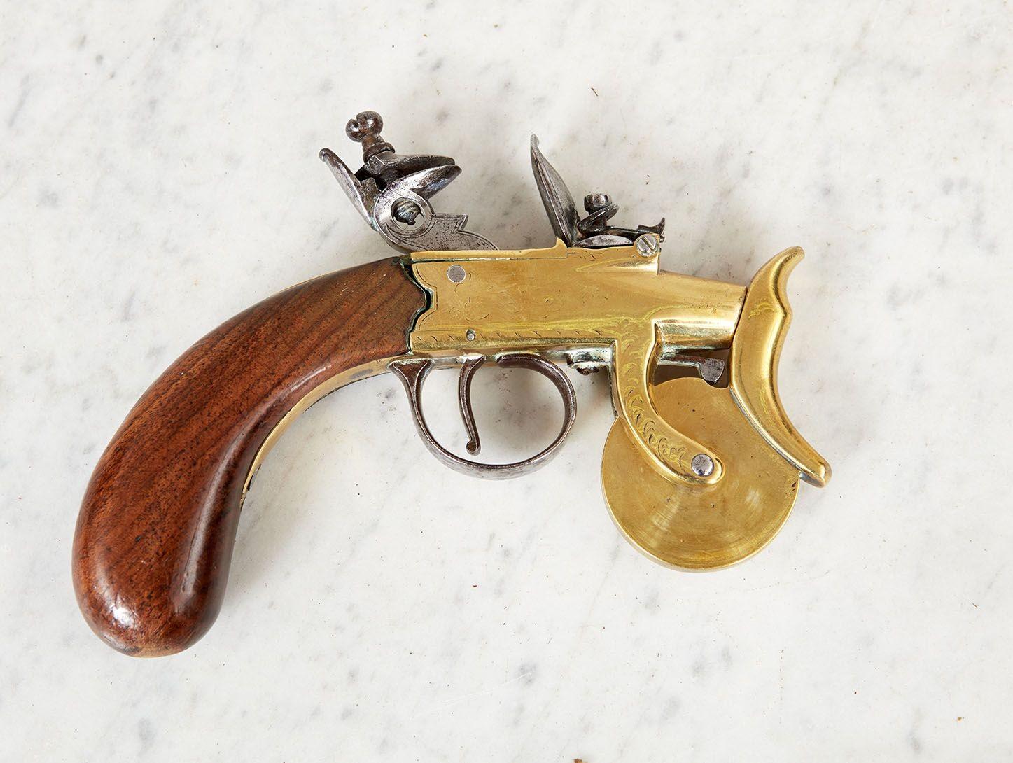 An rare 18th c. flintlock powder tester for the purpose of measuring the strength of gunpowder.  Having a walnut handle with brass body and steel flintlock mechanism.  With gauge makings to brass wheel and further etched decorative designs to brass
