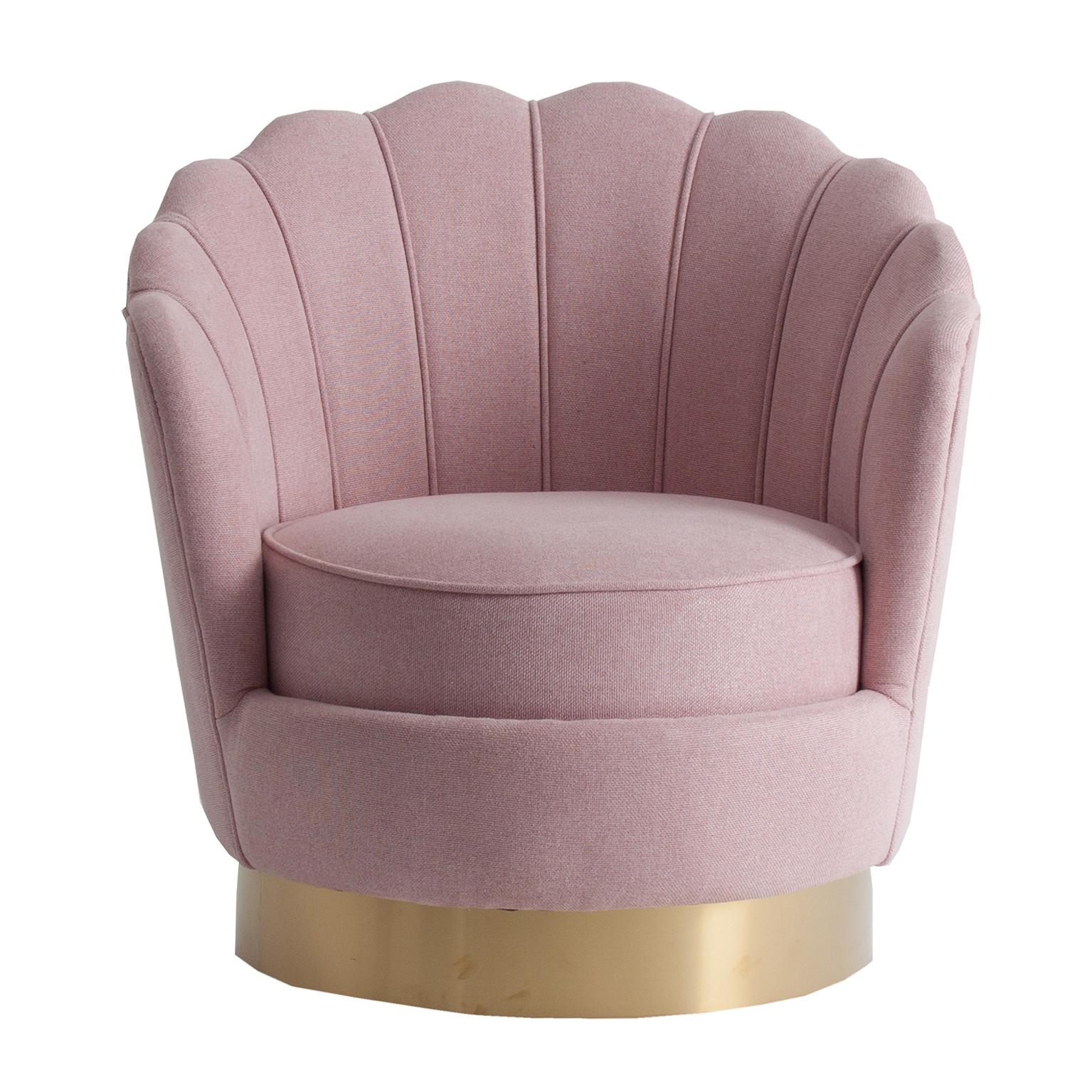 Golden round foot and powdery pink fabric and lounge comfy armchair in Art Deco style.