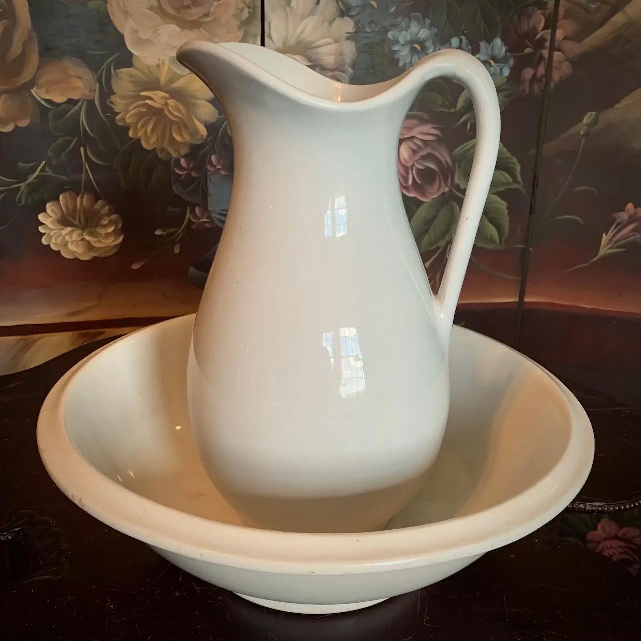 A classic Powell & Bishop ironstone pitcher with original matching basin. A traditional piece of old world history that is both functional and decorative. Capturing the sought after timeless look of Victorian and rustic décor, this authentic pair is