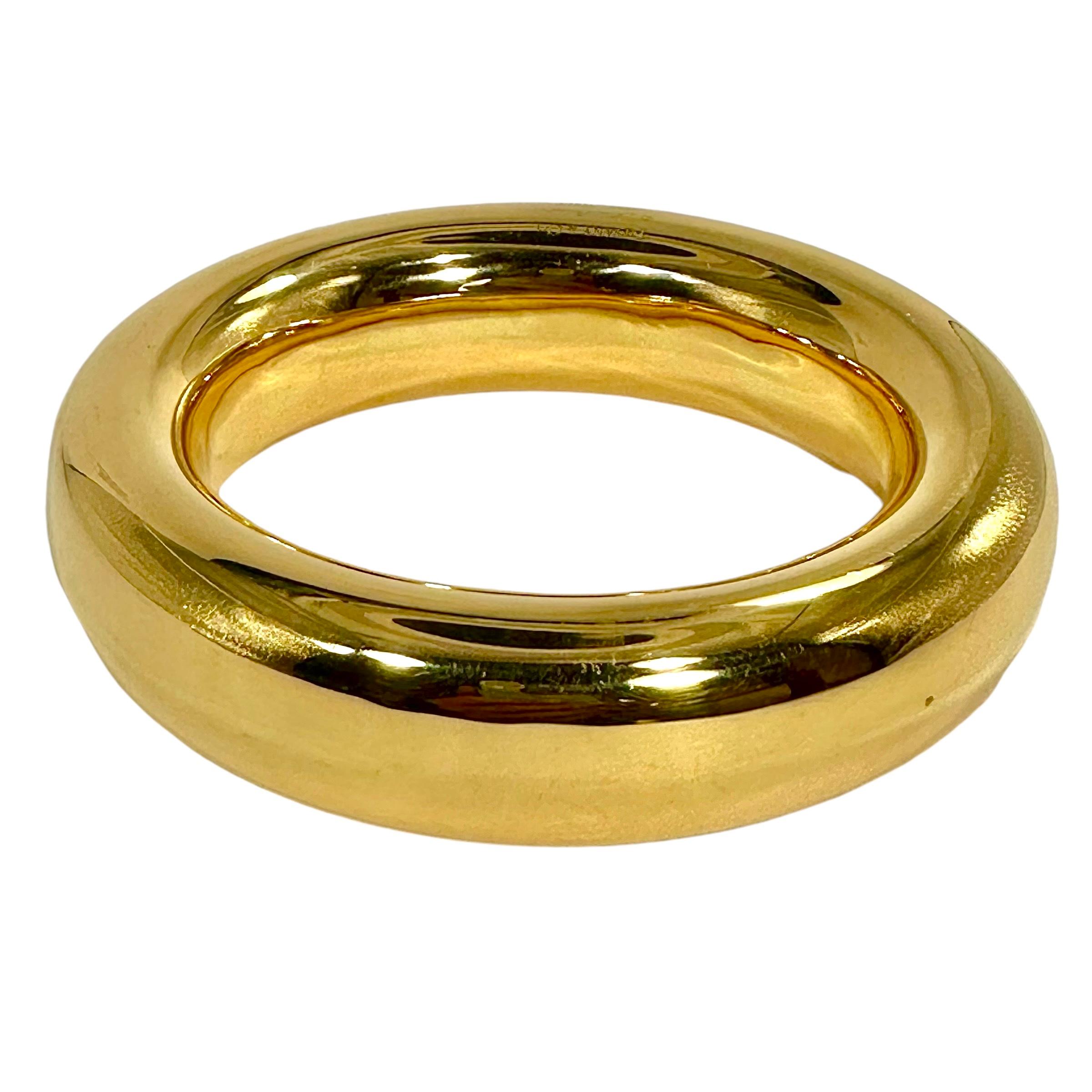 This incredible Elsa Peretti designed, Tiffany & Company 18k yellow gold Doughnut bangle bracelet, exudes all of the creative genius and style of a truly unique Tiffany/Elsa Peretti collaboration masterwork. While it is a very basic form, it's