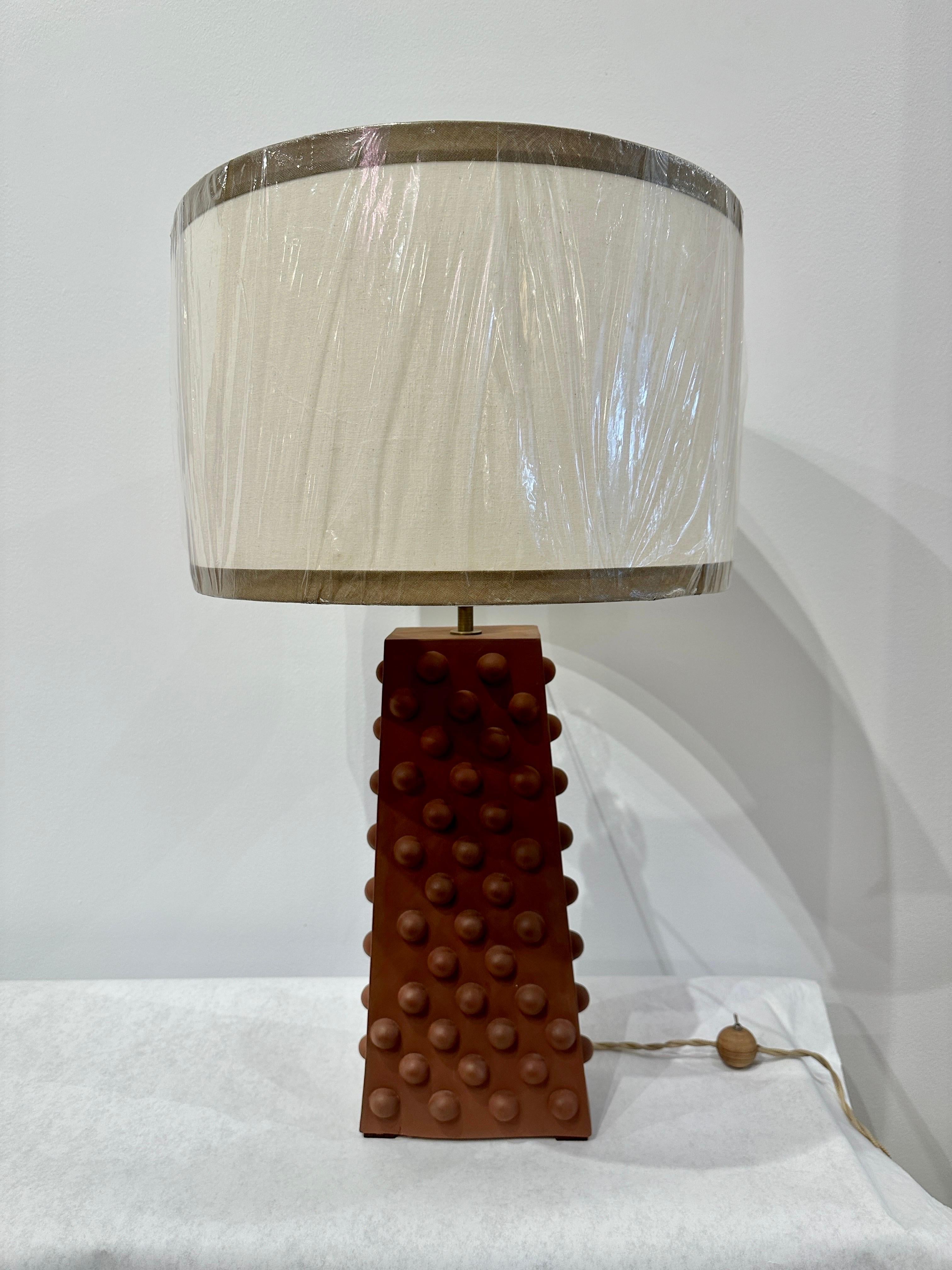This is a wonderfully organic terra cotta lamp with large pox adhesions to the main front and throughout.  Very North African Desert style.  NOTE:  lamp height with shade is 27 inches tall, however the shade shown is NOT included with lamp purchase. 