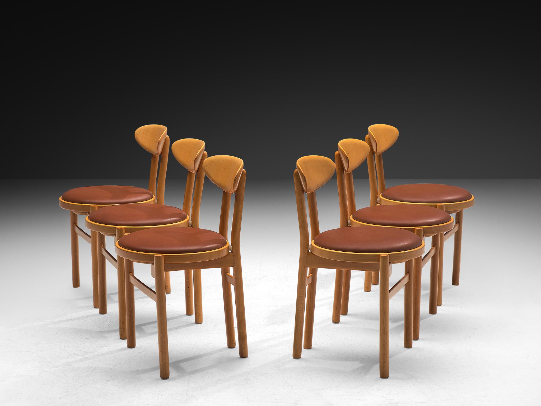 Pozzi, set of six dining chairs, stained beech, leatherette, Italy, 1970s

Lovely set of six dining chairs made in Italy in the 1970s. With their round seats and oval backrests these dining chairs by Italian manufacturer Pozzi feature a dynamic and