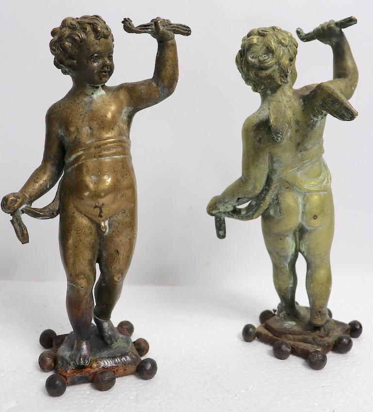 Wonderful pair of 19th century brass, or bronze, winged putti figures - European, probably Italian or French in origin. Each figure has been later mounted on iron square bases, both show wear. Charming decorative objet - offered and priced as a pair.