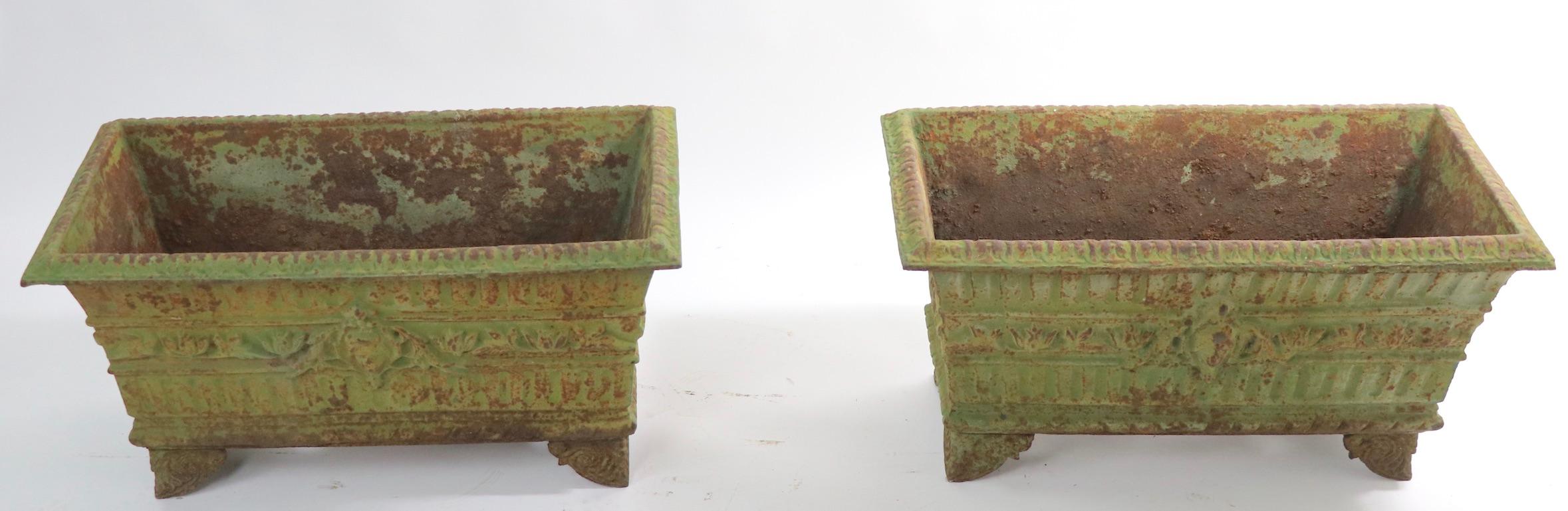 Wonderful pair of 19th century cast iron planters in original finish. Both are in very good, original condition showing expected cosmetic wear to finish, normal and consistent with age. Probably French in origin, unsigned. Offered and priced as a