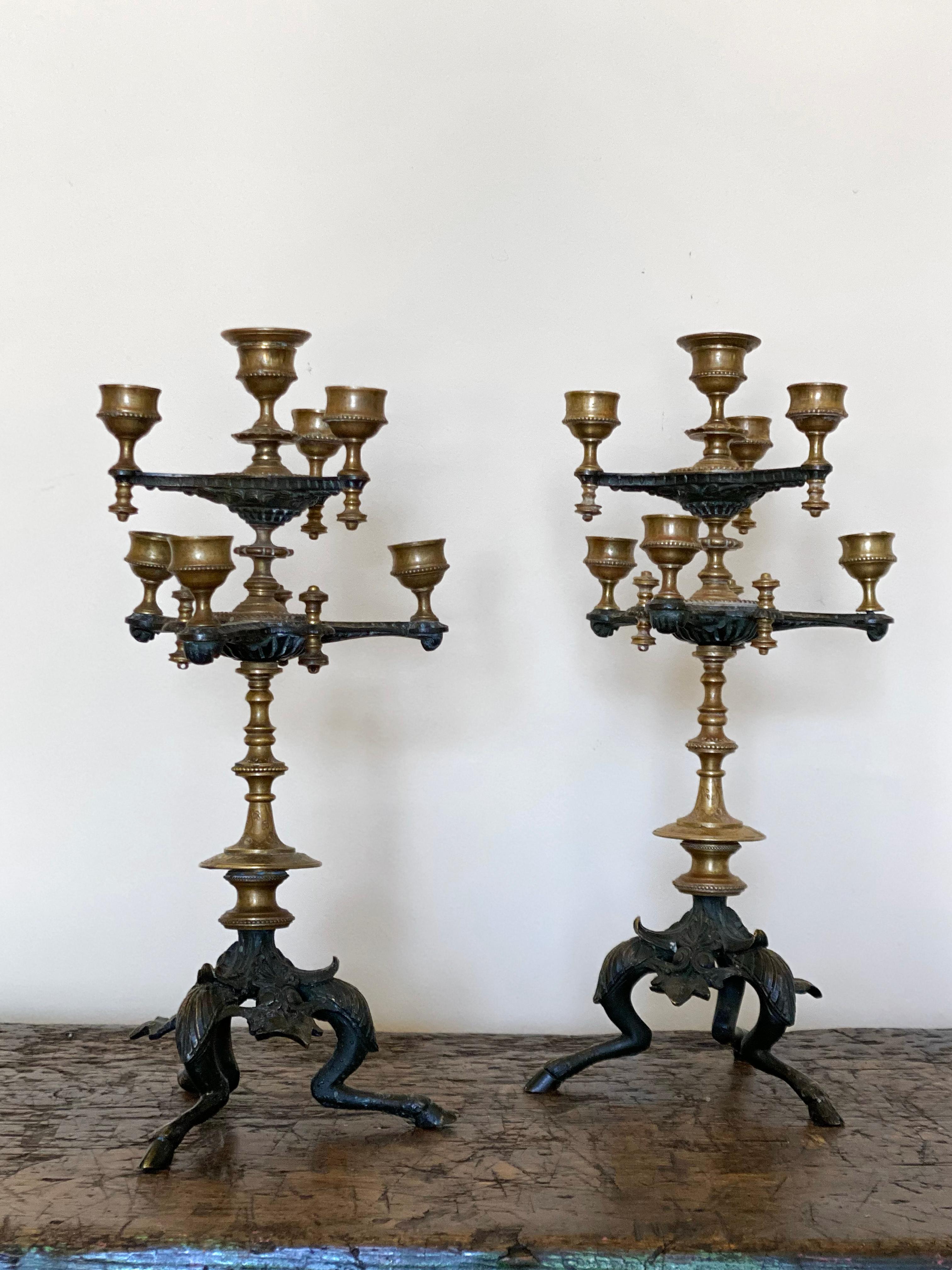 Pr 19th C. French bronze candlesticks 
Cast in brass and bronze. Set on fawn hoofs.
Each holds 7, 1' Candles.