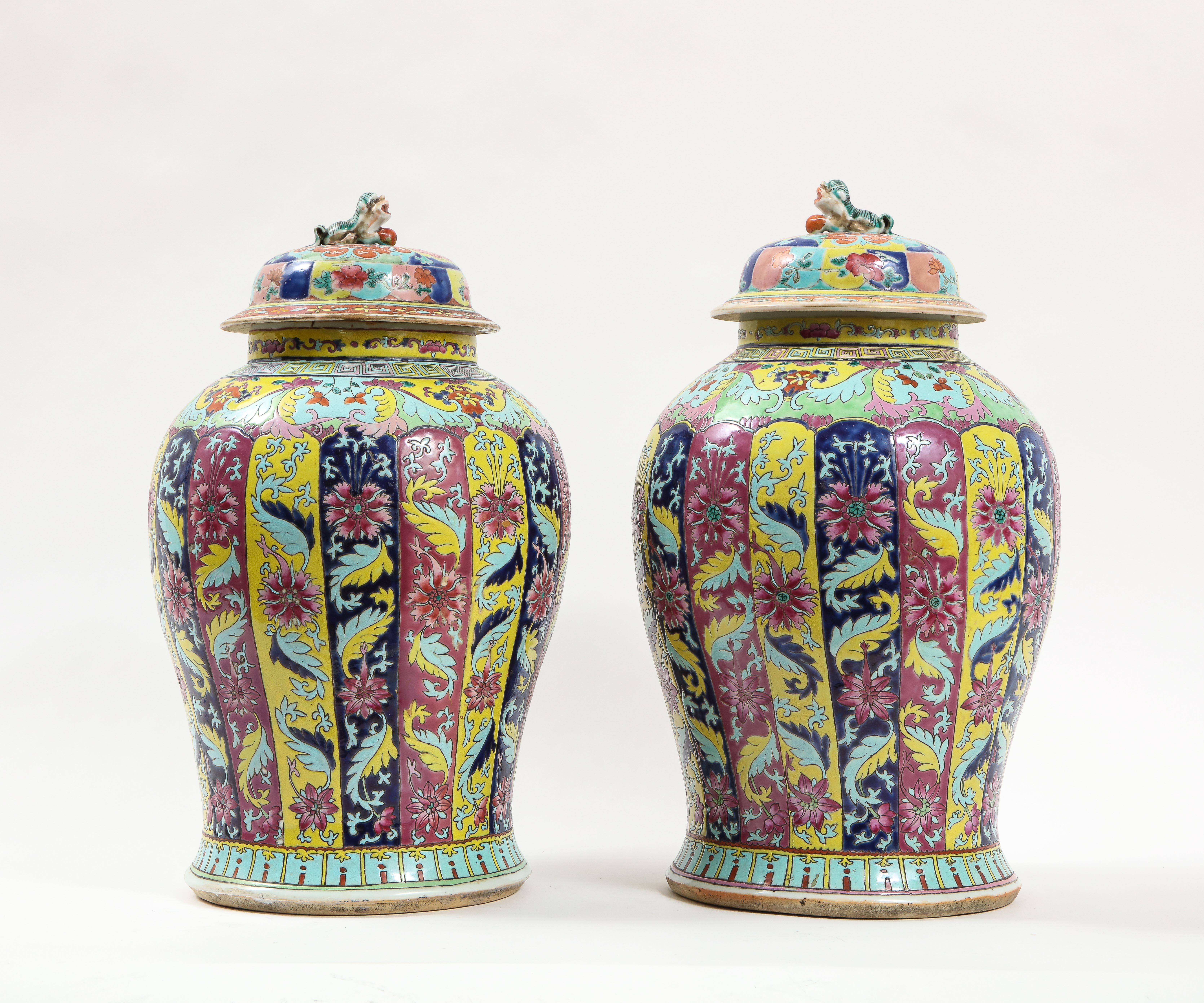 A gorgeous pair of Chinese 19th century Famille rose Baluster Form covered vases, from the Collection of Henry Ford. Each vase is beautifully hand-enameled with a gorgeous array of colors, which include pink, turquoise, cobalt blue, yellow, orange,