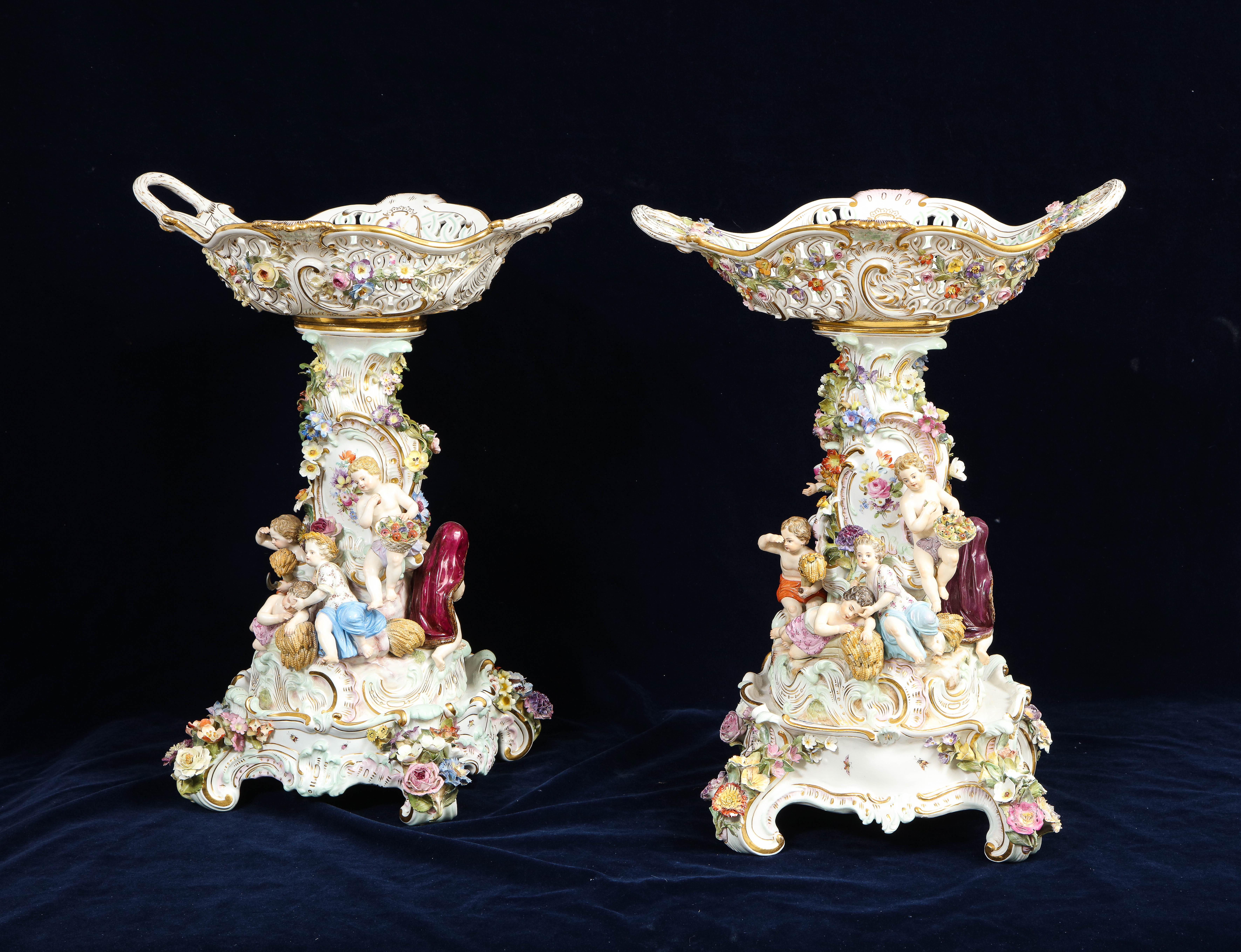 A fantastic pair of 19th century Meissen porcelain Four-Seasons Reticulated Basket-Top Centerpieces with Meissen Porcelain Bases. Each of these is emblematic of the four seasons which include summer, winter, fall and spring. They are both expertly