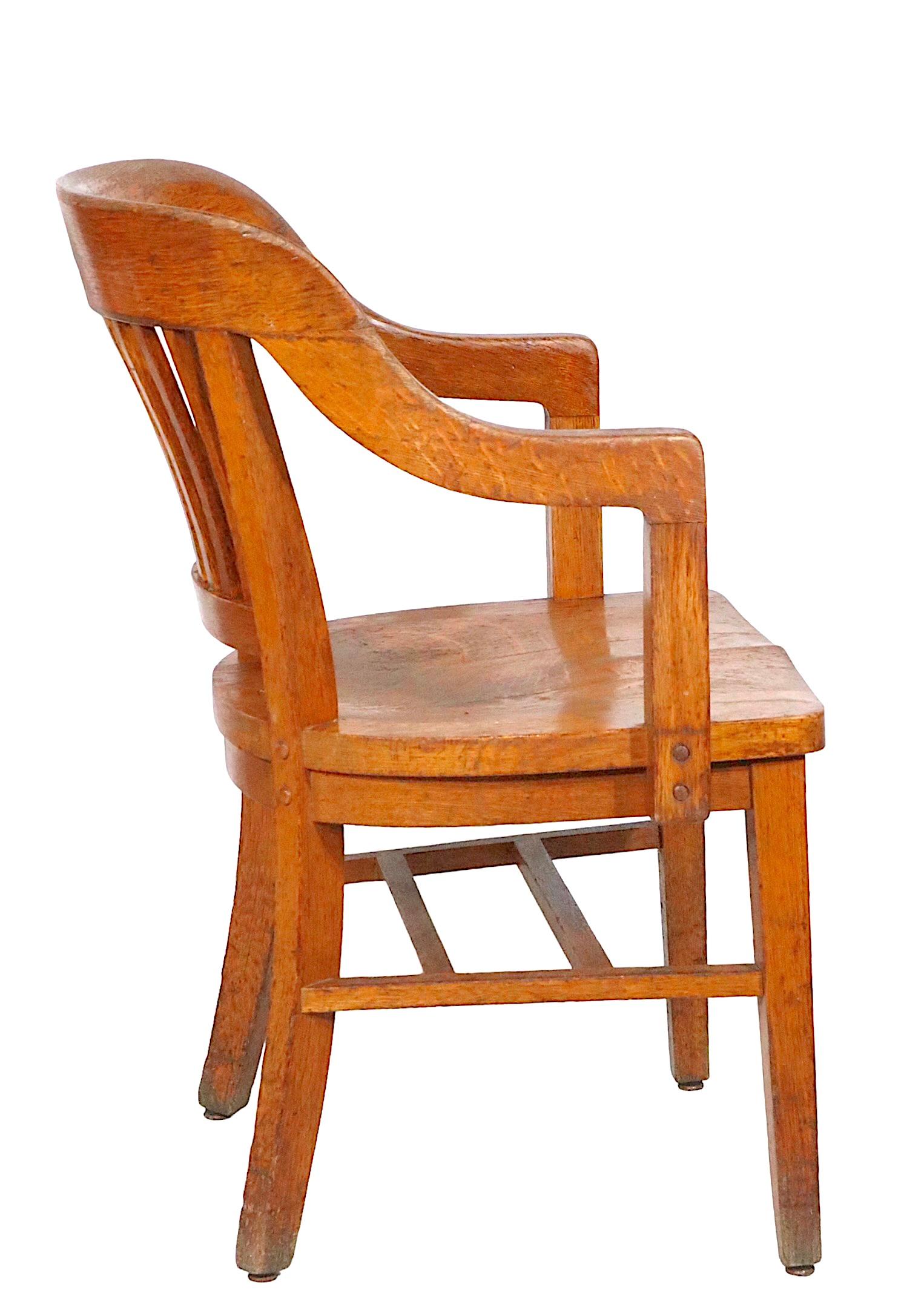 Classic pair of Gunlocke Jury, Bankers, Bank of England chairs in solid oak. Great architectural design, stylish and timeless - The chairs are in good condition, sturdy and ready to use. Condition report as follows.
 One chair shows repairs,