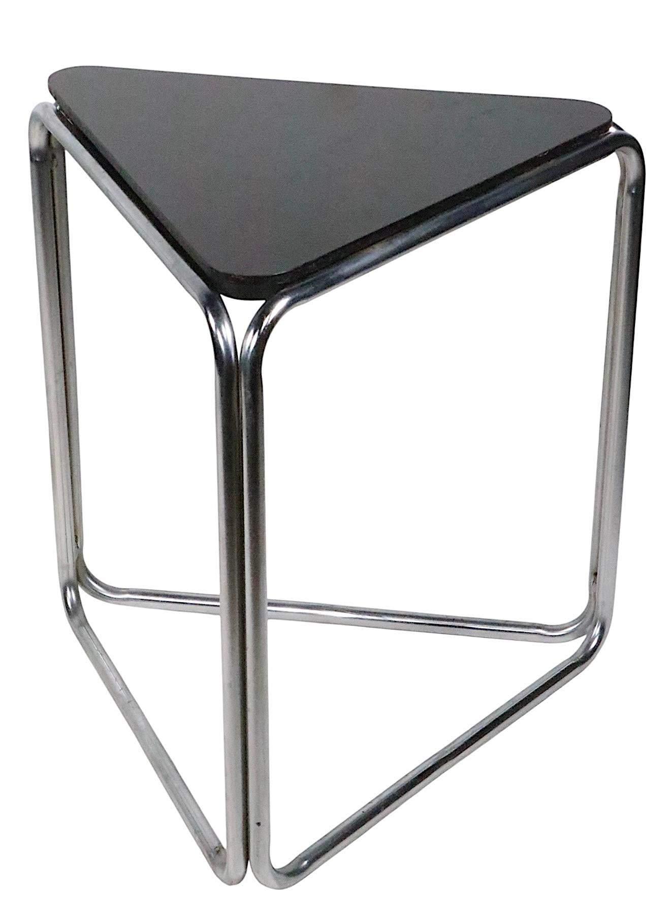 Rare paire de tables d'appoint ou de chevet d'influence Bauhaus, Art Deco, Machin, constituées de bases tubulaires chromées et de plateaux triangulaires en bois d'origine. 
 Le design rappelle Gilbert Rohde, KEM Weber, Marcel Breuer etc. ces pièces