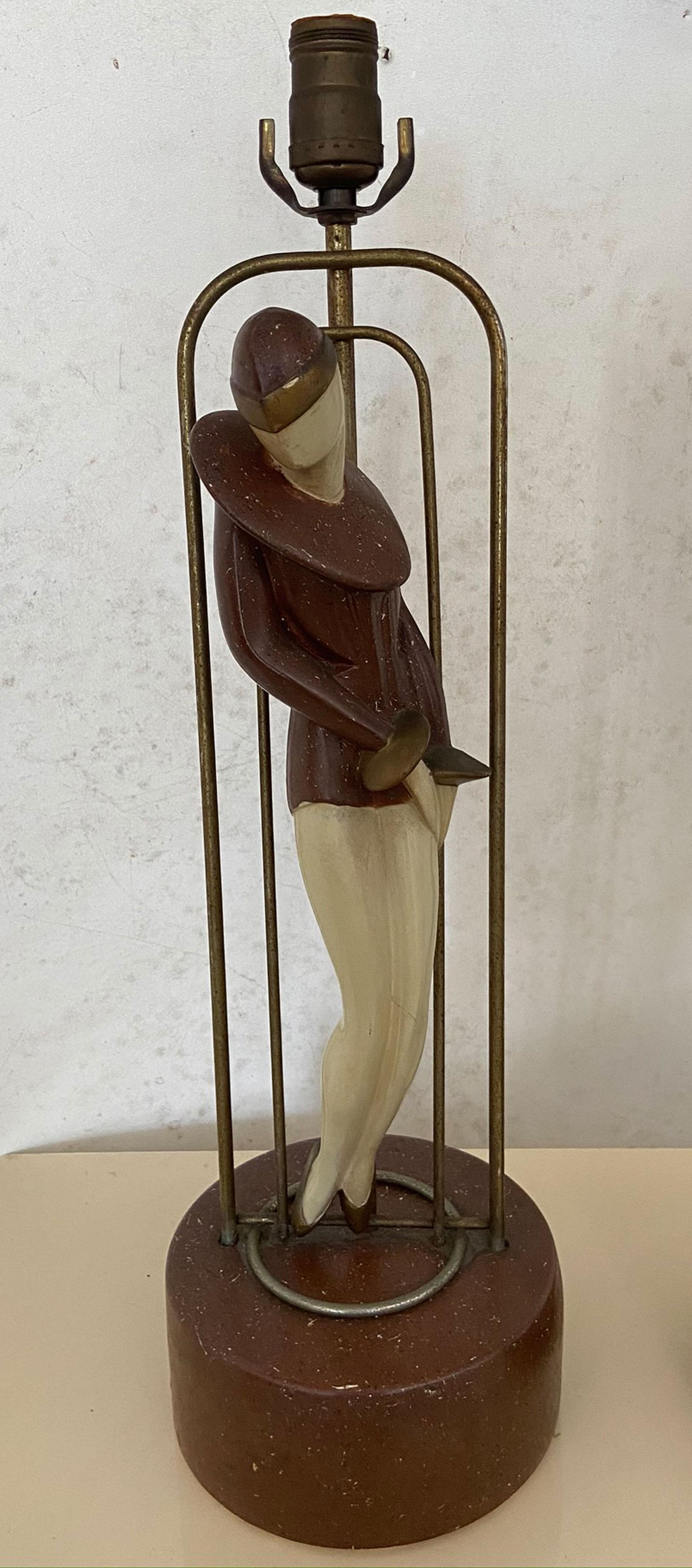A vintage pair of Art Deco Lamps. Flapper women mounted on metal frame work. Base and women are polychromed plaster. Original finish no repairs or touch ups. Both Impressed copyright 1954 Fordyce. Women figures are 15.5 inches tall over all height
