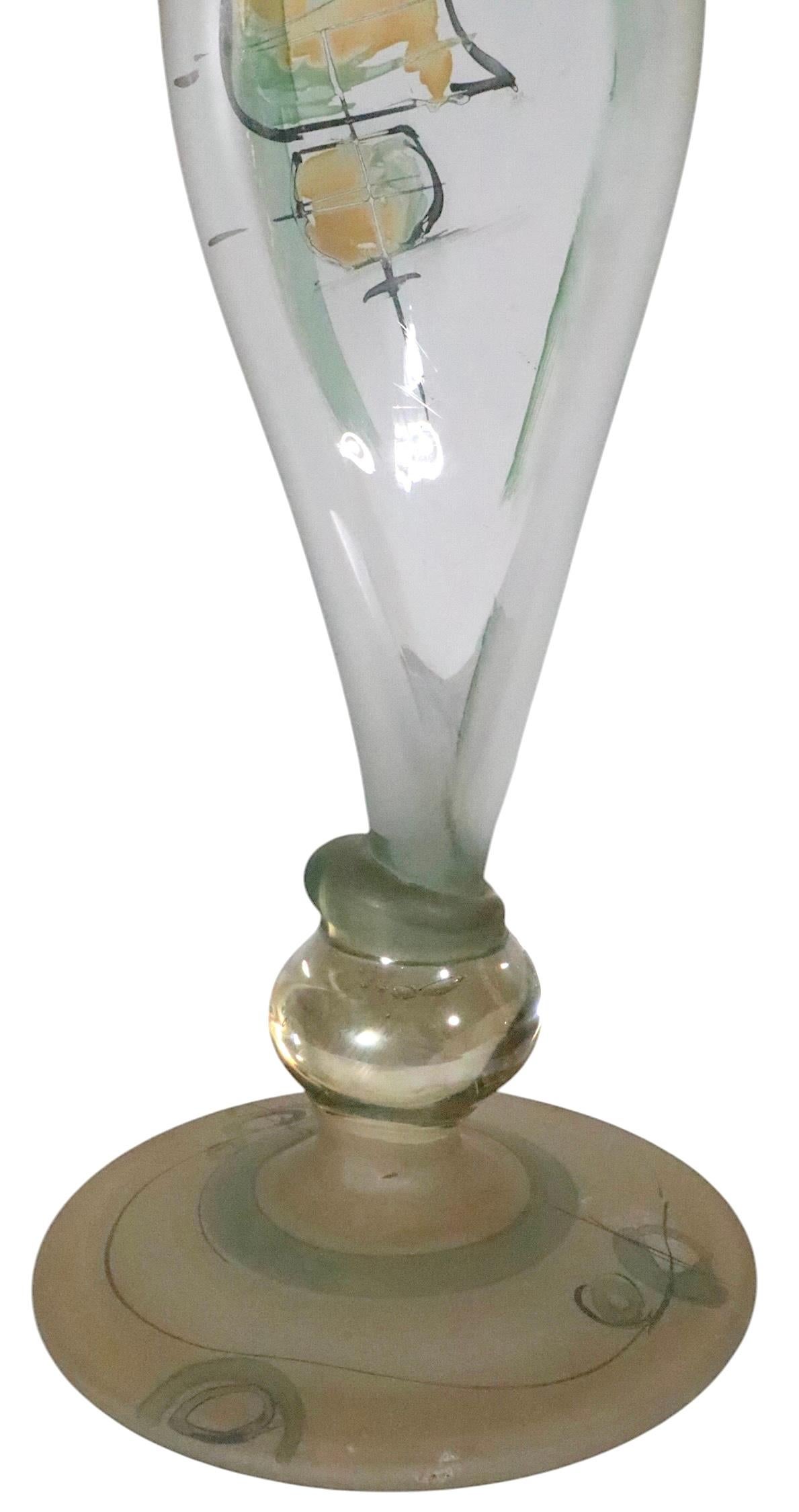Exceptional pair of art glass candlesticks, made by the noted Romanian  craftsman, Ion Tamain. Both candlesticks are signed, both are in excellent condition, free of damage or repairs. 