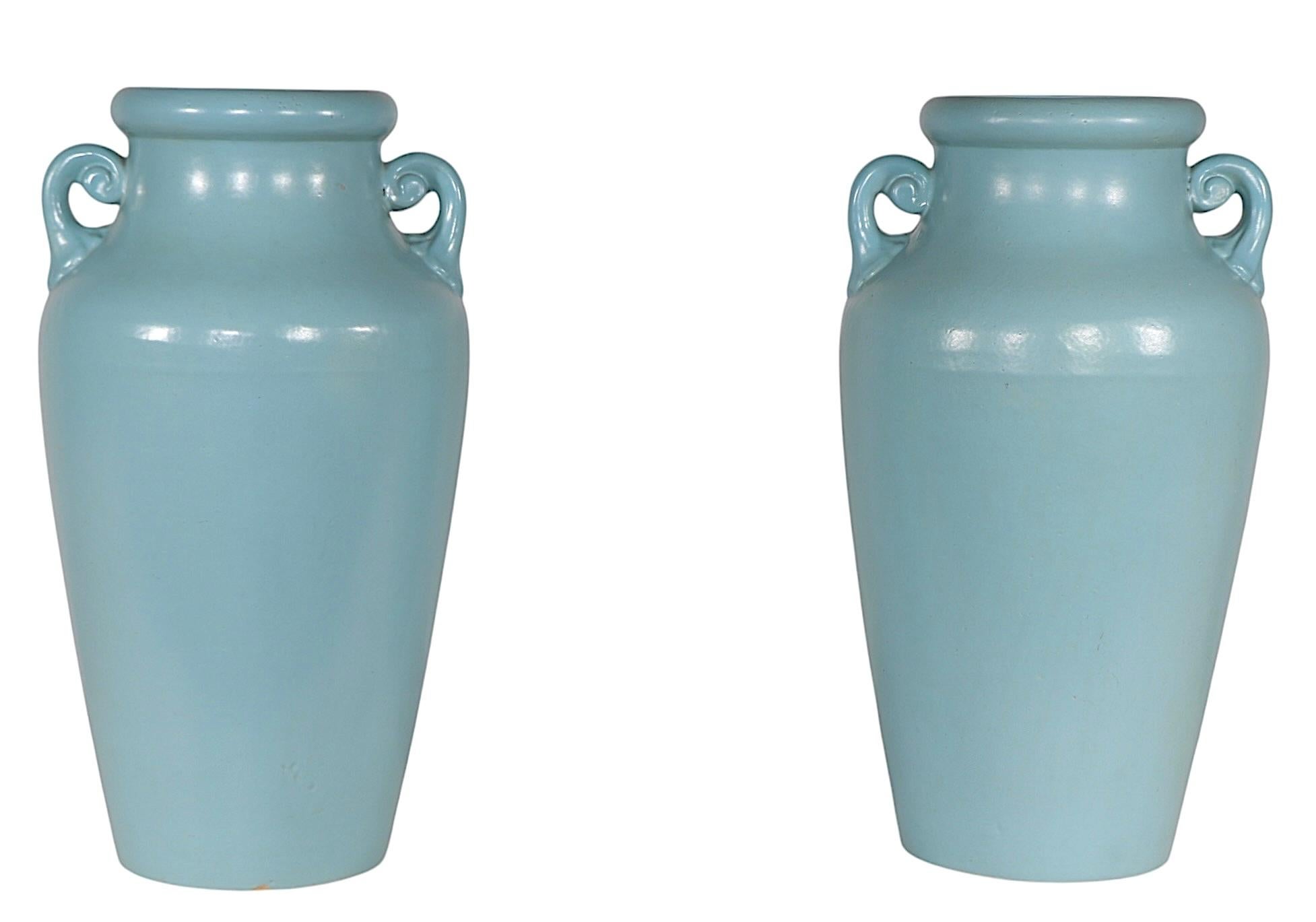 Pair of vintage Art Deco pottery vases, circa 1930/40's,  marked U.S.A. 151/150 on verso, as shown. Executed in robins egg blue, shouldered form with two decorative handles . The vases are in very fine, original clean and ready to use condition, one