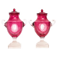 Pr. Baccarat Red Cut-to-Clear Covered Vases w/ Central Cameo of Hunting Trophies