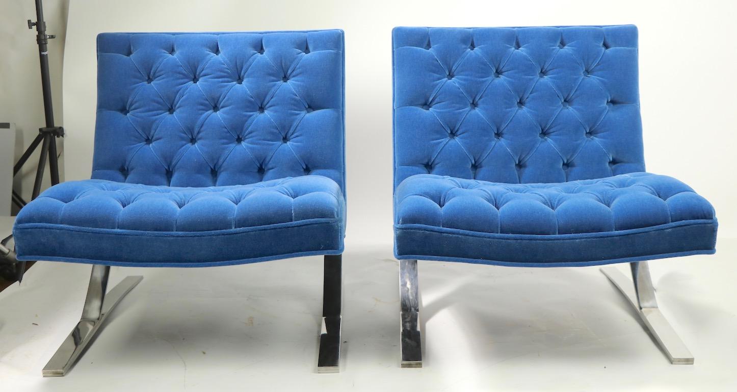 Chic pair of cantilevered lounge chairs after the iconic Barcelona chair. Newly reupholstered in sophisticated and voguish French Blue mohair, making these midcentury International Style classics completely contemporary and up to date for today’s