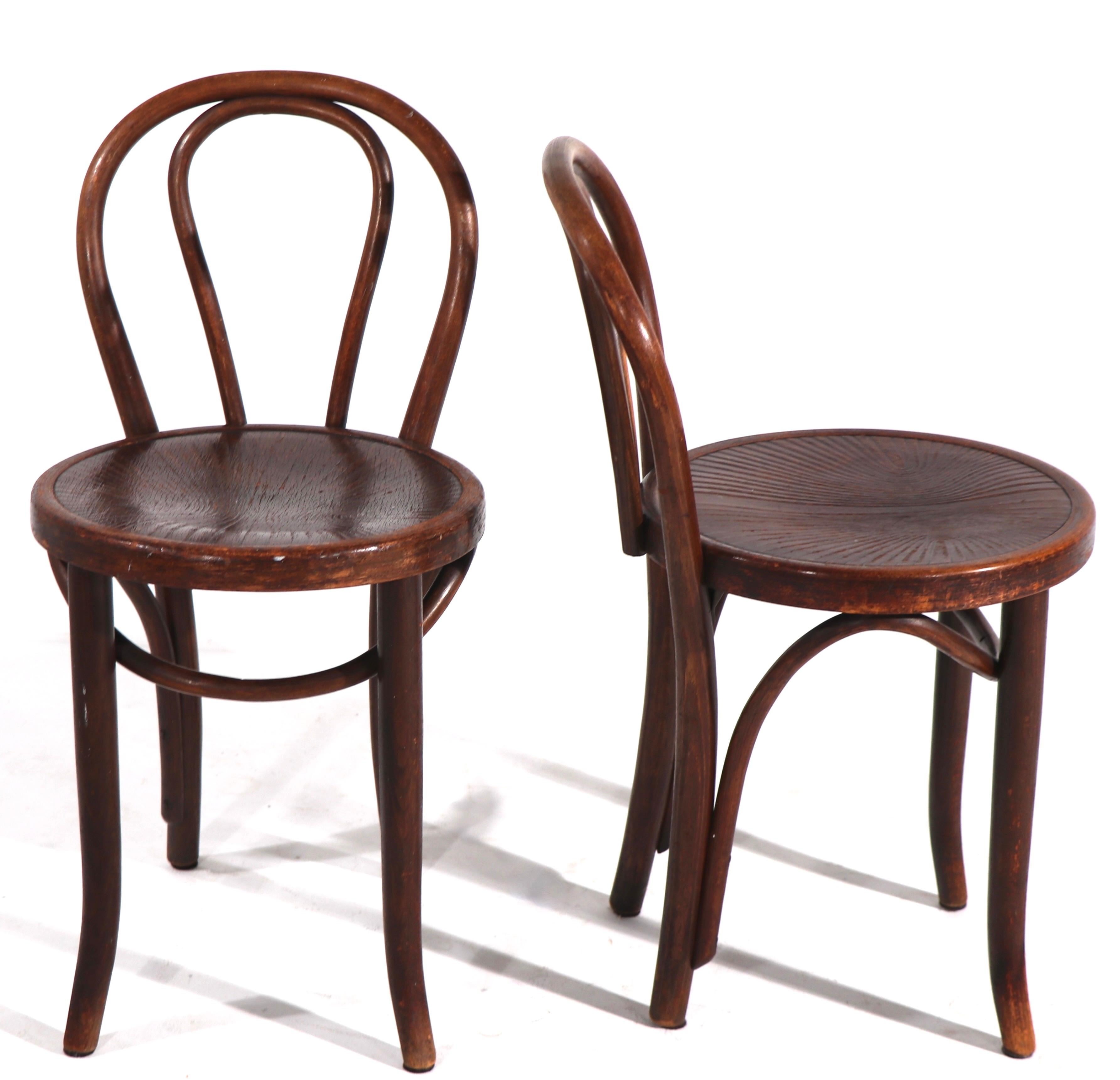 Pair classic bentwood side chairs by Thonet, in clean original, ready to use condition. Early bentwood chairs from the Vienna Secessionist period - This model has an unusual low back support, with a pressed wood seat - The chairs are labeled Thonet.