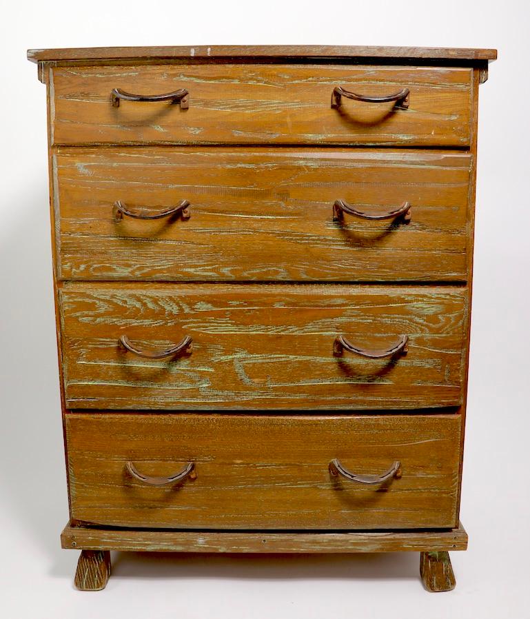 Fun rustic, western, cowboy style chests, each having four drawers with stylized horse shoe handles. The dressers are solid oak, in original cerused finish. We have priced these and are offering them individually, but would love to see them stay
