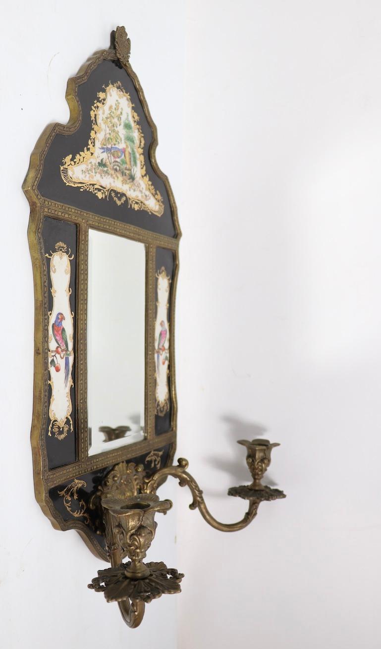 Impressive pair of mirrored candle sconces marked WL (William Lowe) with blue crown mark. One sconce has a crack in the upper porcelain section, please see images. Very decorative and charming, possibly 20th C. vintage.