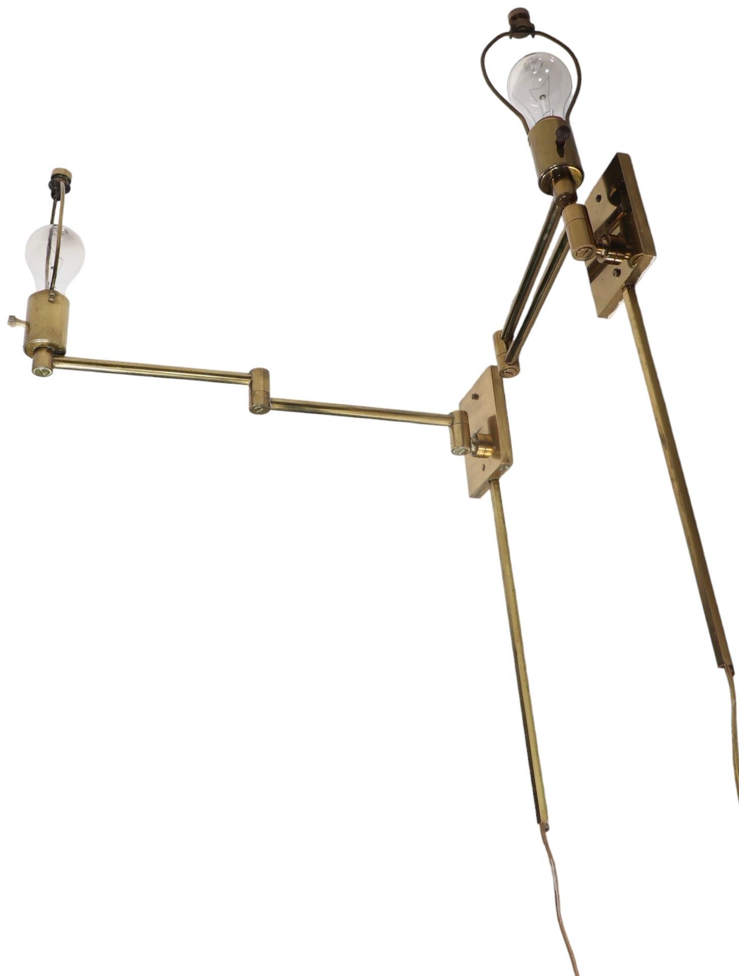 Pair of chic architectural brass flex arm sconces by Hansen Lighting Co. NY, circa 1970's. The sconces are constructed os solid brass, each having a rectangular backplate ( 4.5 H x 3.5 W in. ) which have a flex arm of two brass tubes ( 9 in. each )
