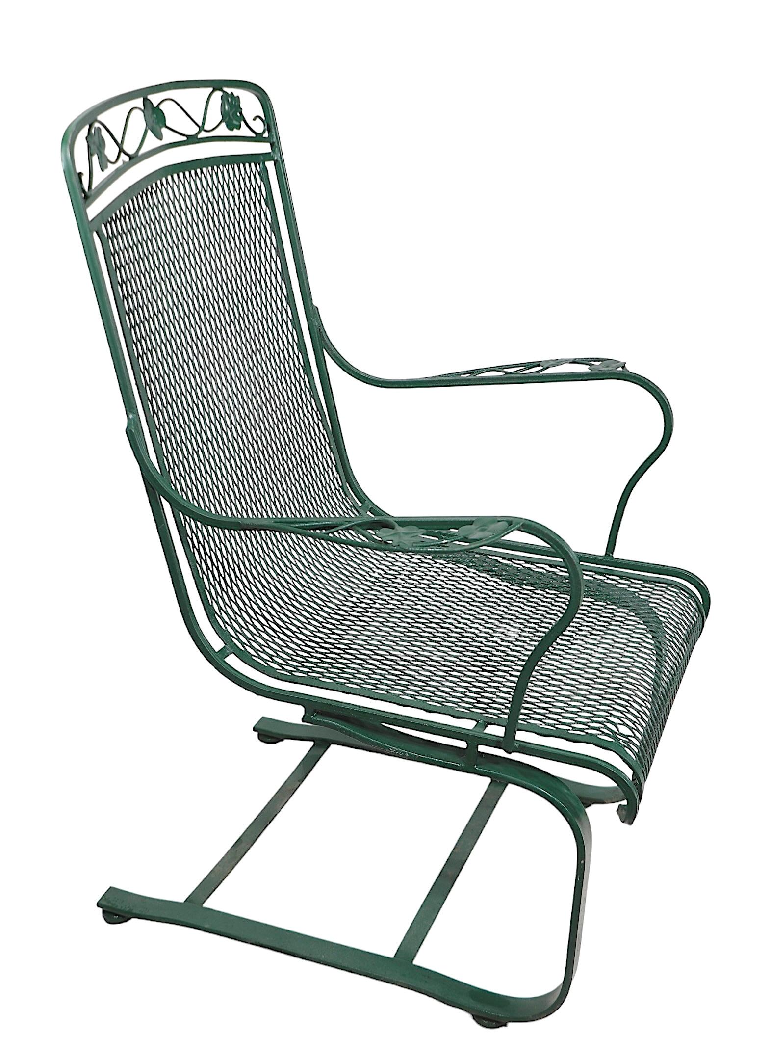 Pair of wrought iron and metal mesh cantilevered lounge chairs, by Meadowcraft, as part of the Dogwood pattern series, circa 1950/1970's. The chairs are in very good, clean, original, ready to use condition, showing only light cosmetic wear, normal