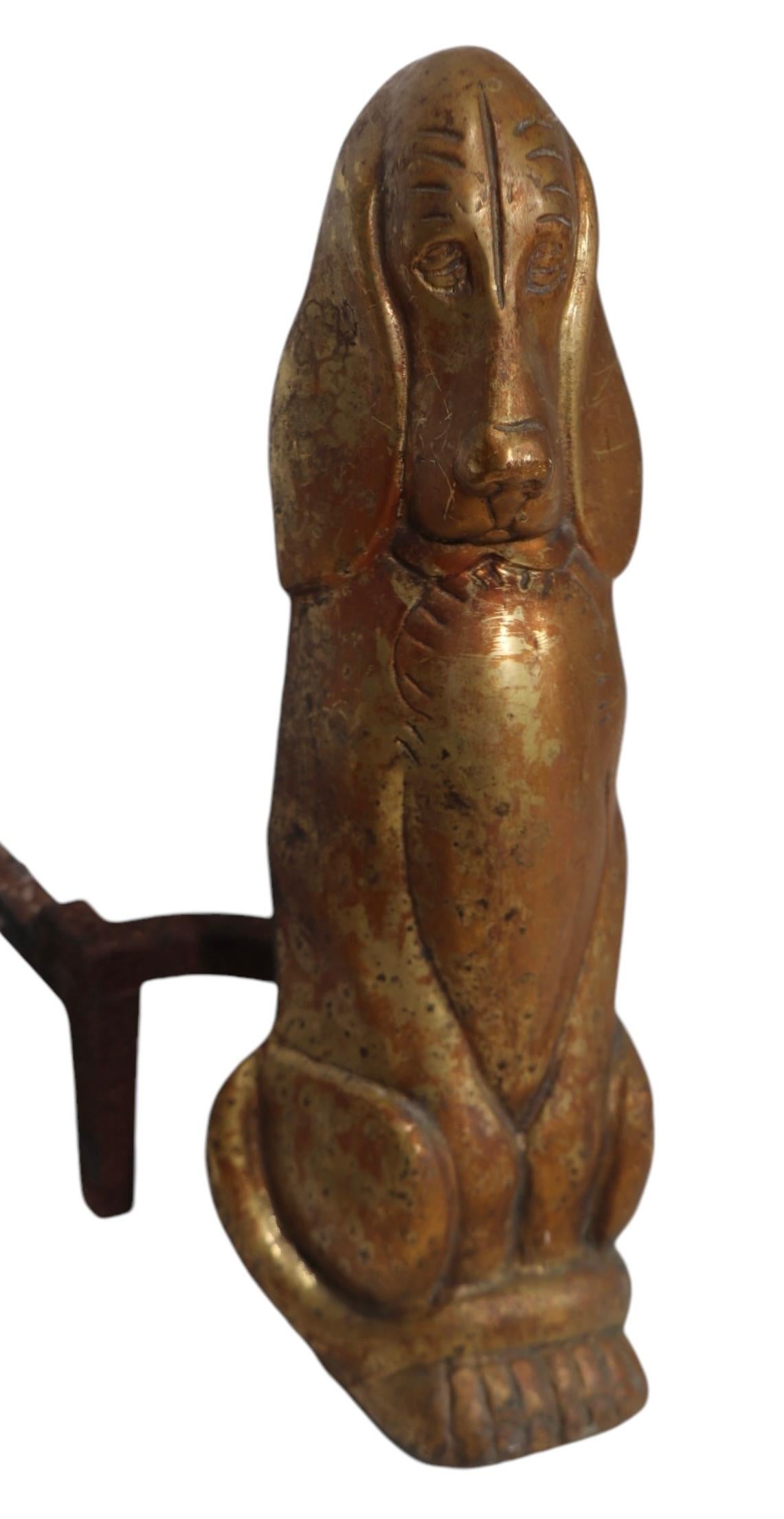 Pair of vintage  cast brass fire dog, andirons, in the form of Bassett Hounds, with cast iron billet bars.  Both are in very good, original, ready to use condition, both show cosmetic wear, normal and consistent with age.
 Produced in the first half