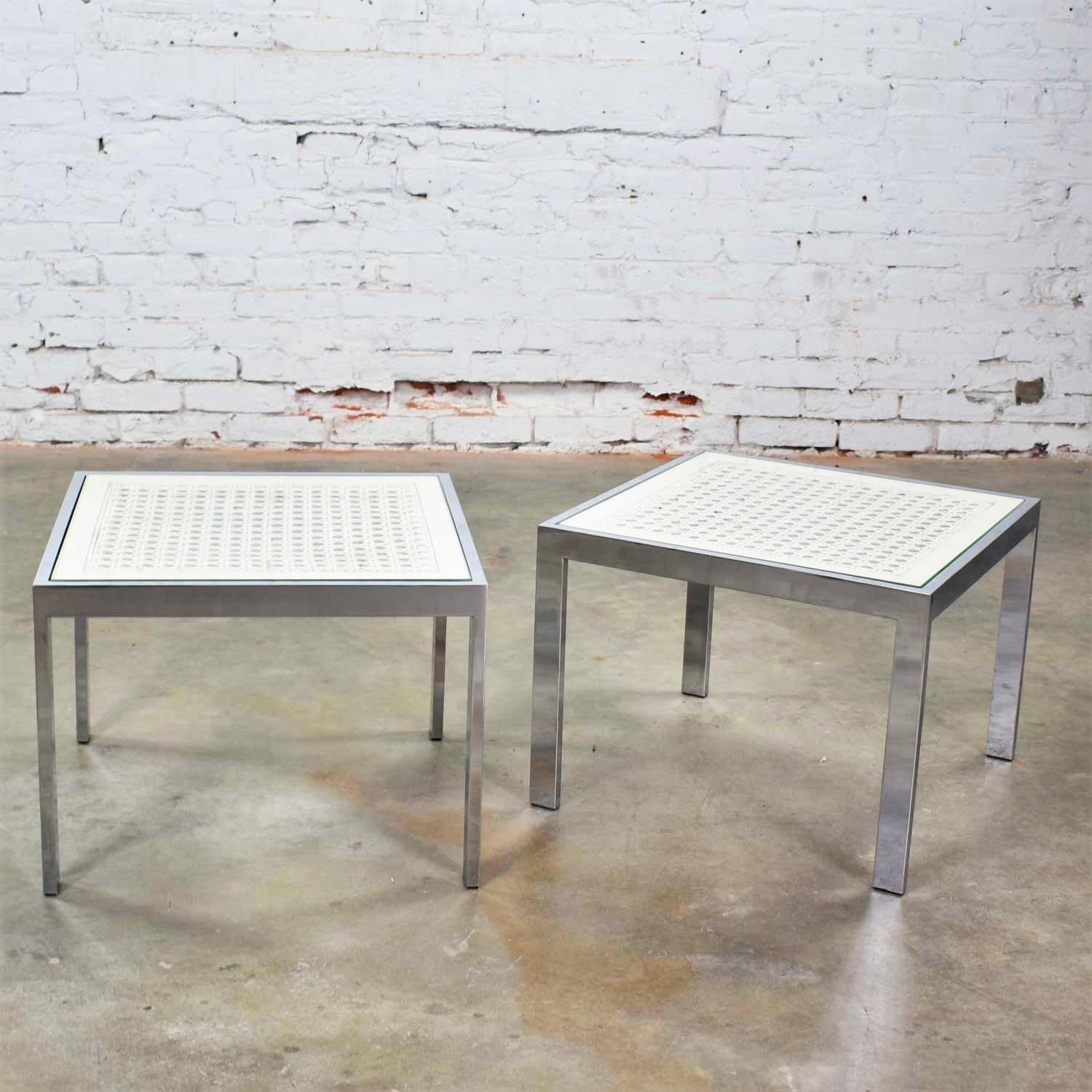 Handsome pair of square Mid-Century Modern to modern Parsons style side tables or end tables comprised of a rectangular chrome tube frame with a white painted cane and glass insert top. They are in wonderful vintage condition. We have given the cane