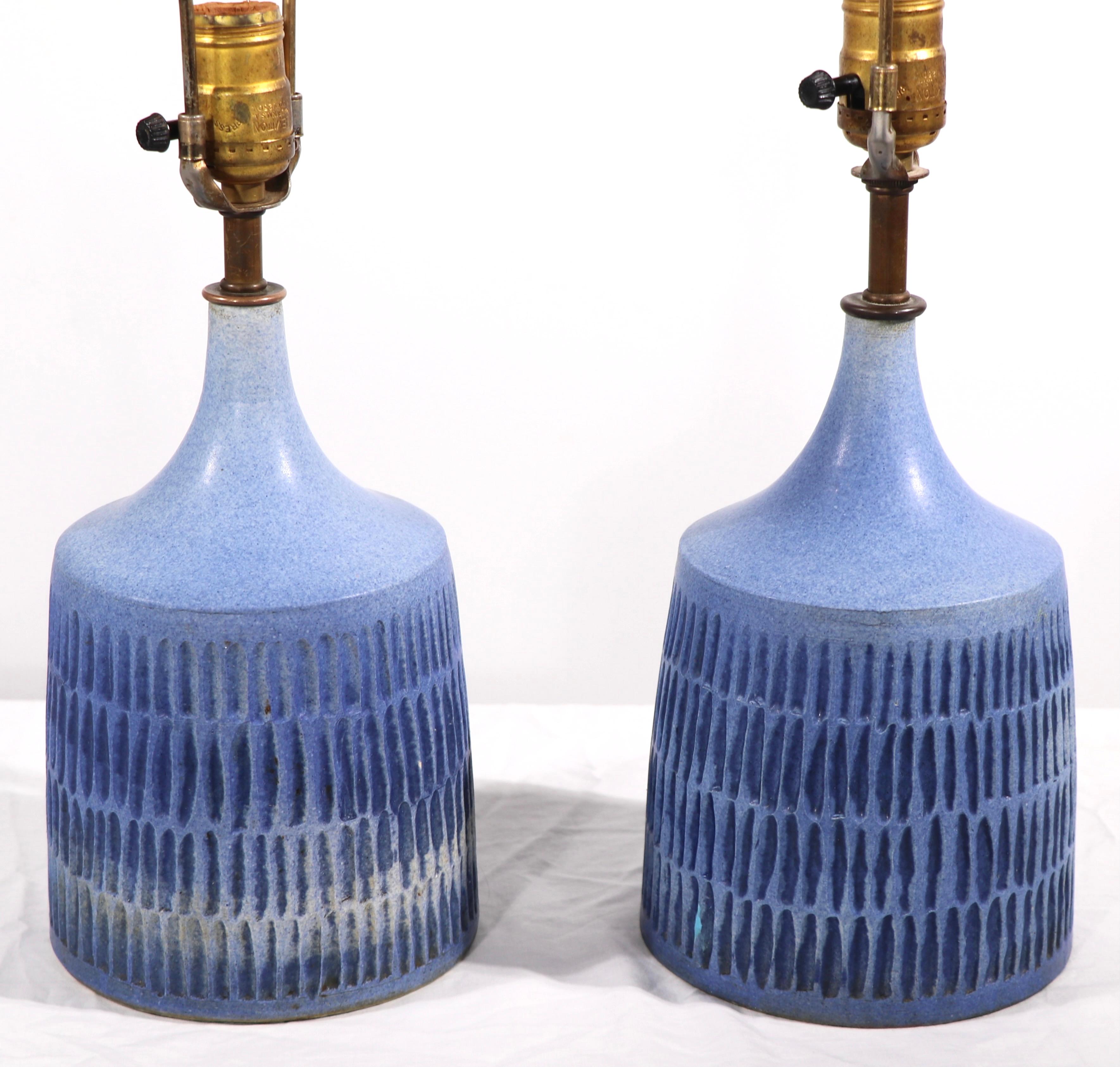Sophisticated architectural ceramic table lamps ocean blue with textural surface. Both are in good original, clean and working condition, one has a recolored glaze flaw, please see images. In the manner of Sohoim, unsigned. The lamps are offered as
