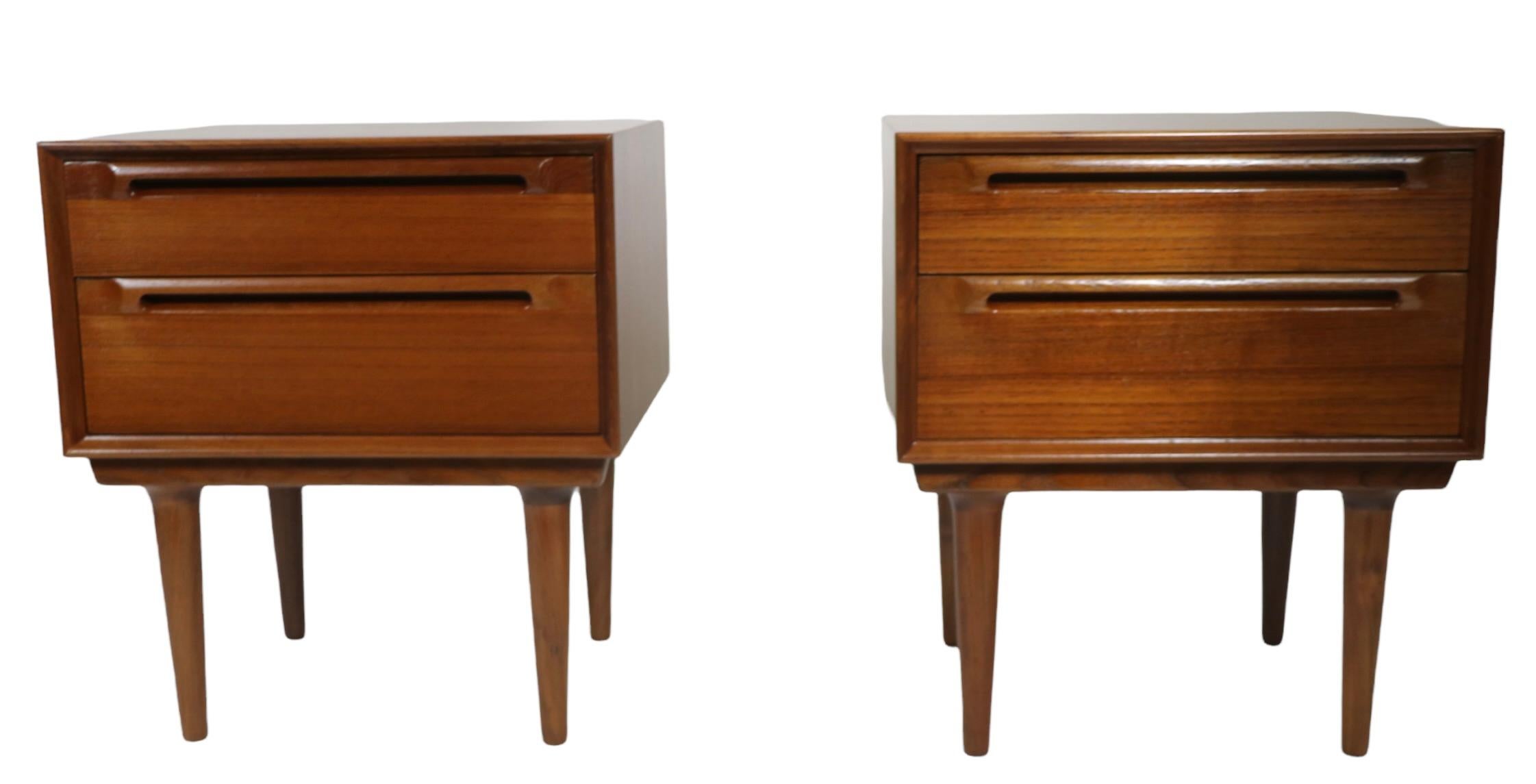 Exceptional pair of Danish Mid-Century Modern night stands, attributed to Sven Ellekaer. The nightstands feature two drawers, the lower drawer being deeper than the upper drawer. Both are in exceptional condition, having been newly professionally