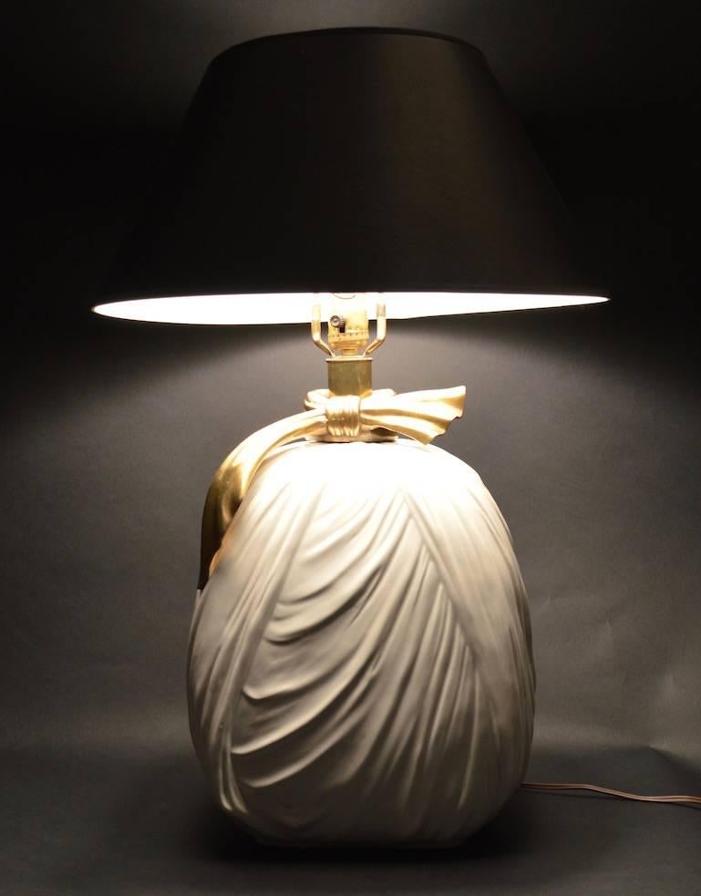 Ceramic cloth body with brass bow at top, glamorous and chic lamps by Chapman. Both are in working, clean condition, one shows minor loss to glaze, as shown. Shades not included, H to top of ceramic body 15 inches.