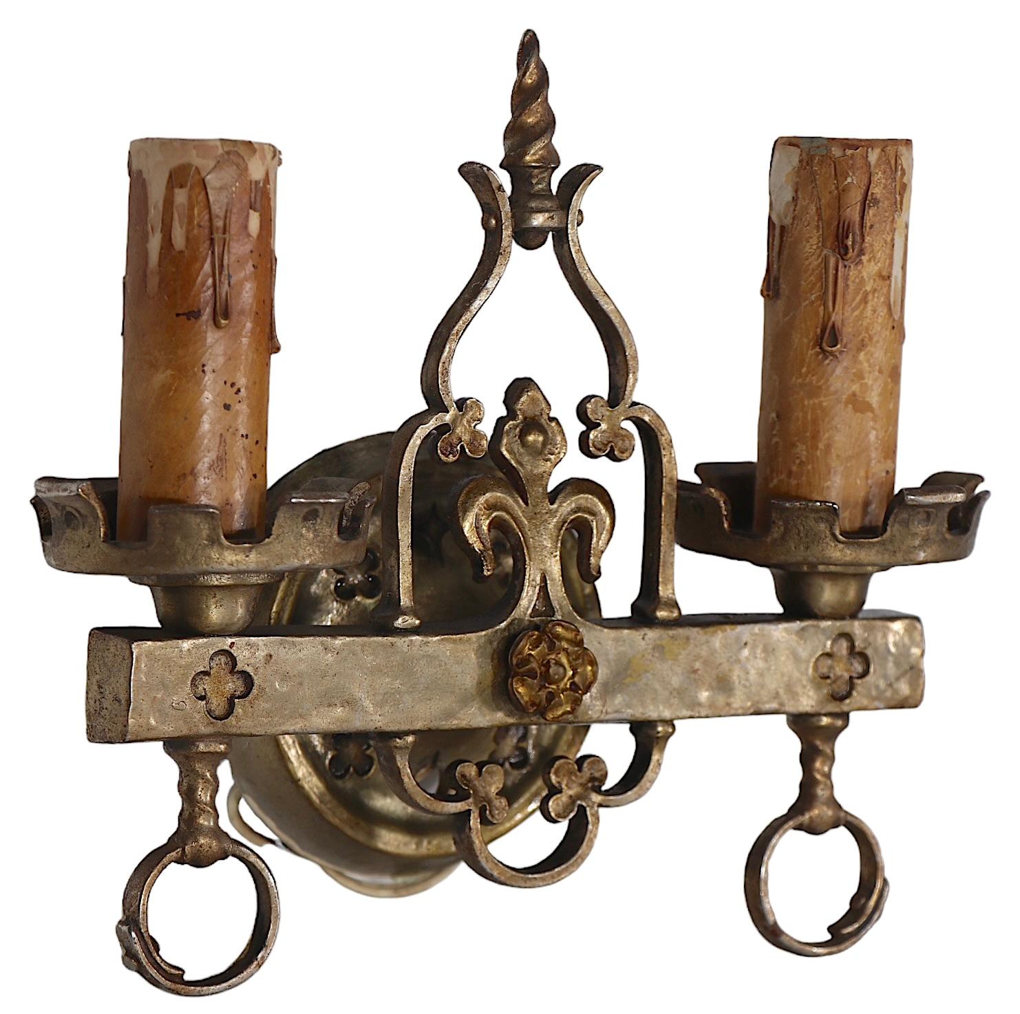 Exceptional pair of Gothic Revival, Arts and Crafts style sconces by noted American maker Lion Electric Mfg.Co. c.1920/1930's.  Each cast brass sconce features two candle light fixtures,  each accepts a standard size screw in bulbs. Both are in