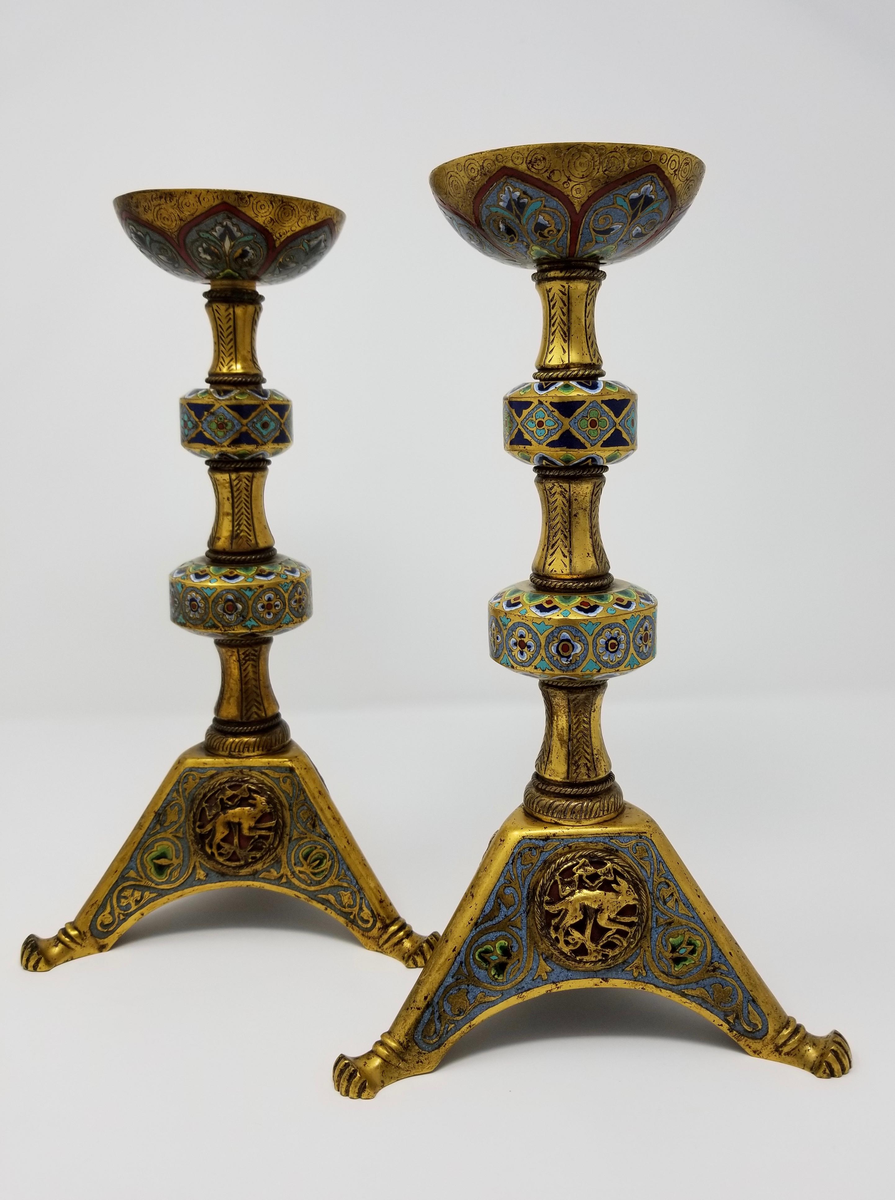A very fine and unusual pair of antique bronze and champlevé enamel candlesticks/lamps, by E. F. Caldwell, in the Renaissance Islamic/Orientalist taste. Around the lower base are three raised plaques with motifs of a deer, fox, and duck. Found