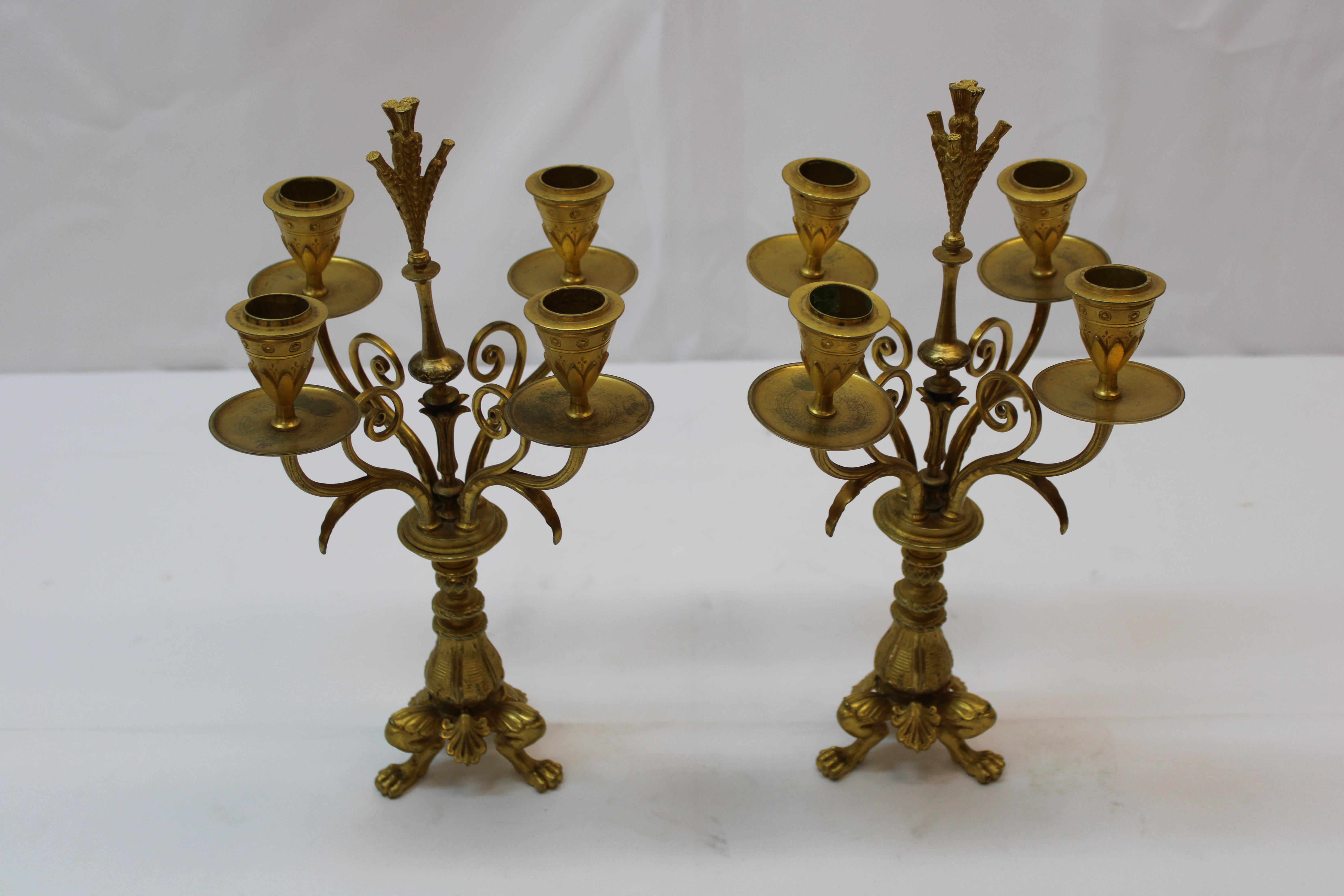 Pr four arm gilded candlesticks, 19th century with lion paw feet.