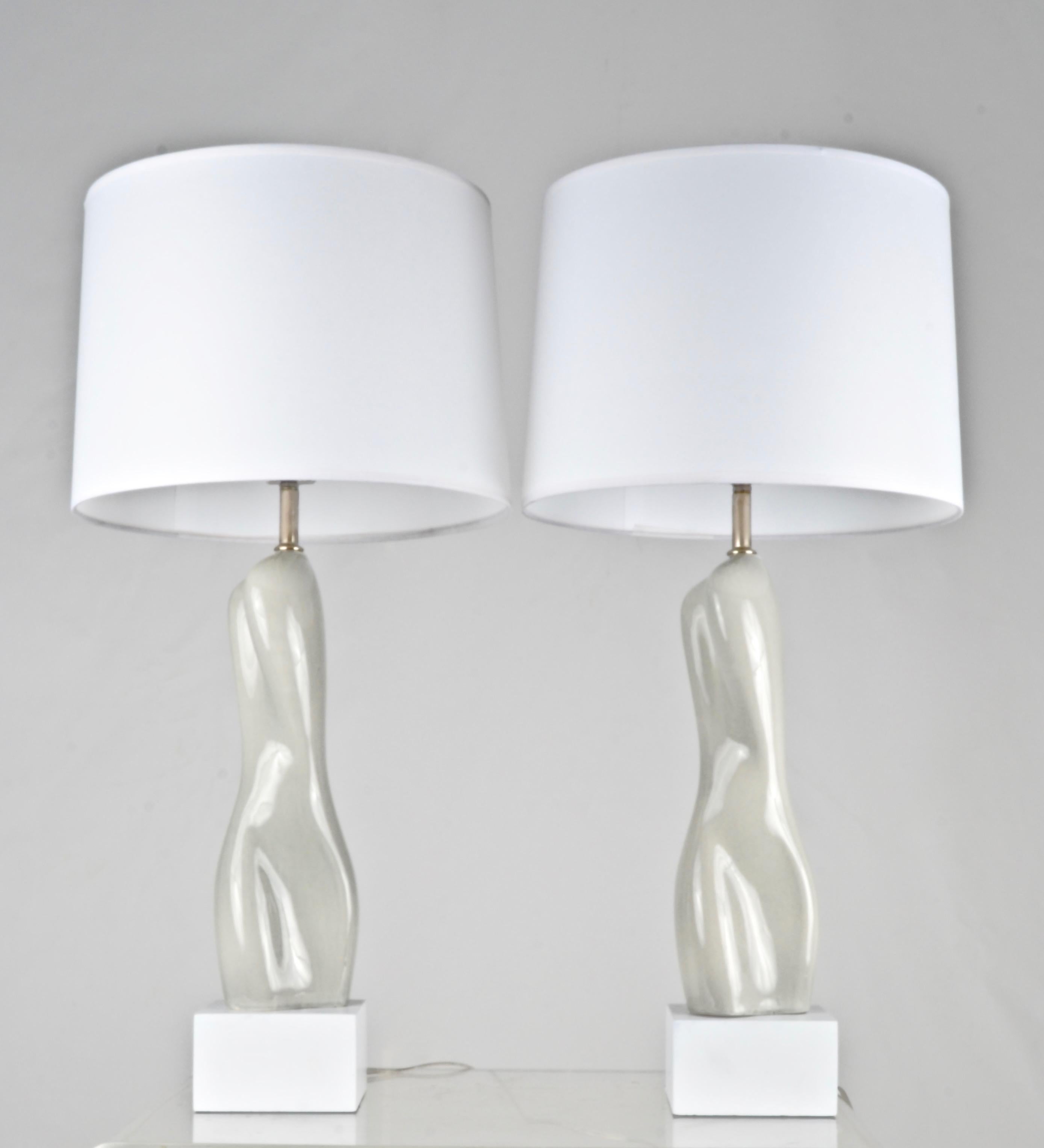 A very appealing pair of vintage ceramic lamps featuring an abstract female form. Glaze is a pale grey blue. The lamps have been completely refreshed including a new chrome lamp conversion with 3-way switch, white painted bases and new wiring and