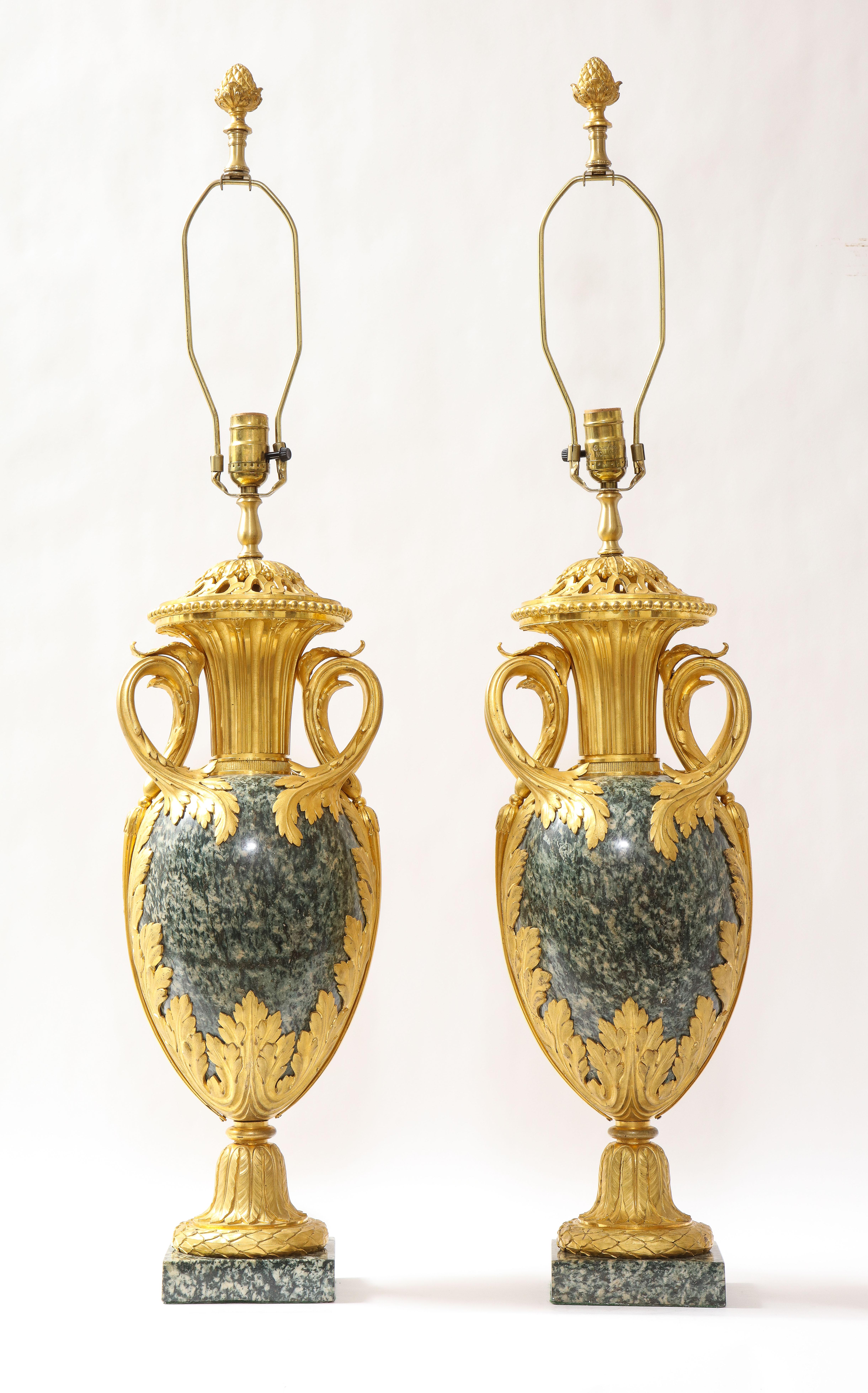 A fantastic and quite large pair of French Louis XVI style dore bronze mounted green marble or possibly Greenish/Grey Porphyry Pot-Pourri vases mounted as lamps, attributed to Henry Dasson. The bronze mounts are fabulously cast, hand-chiseled, and