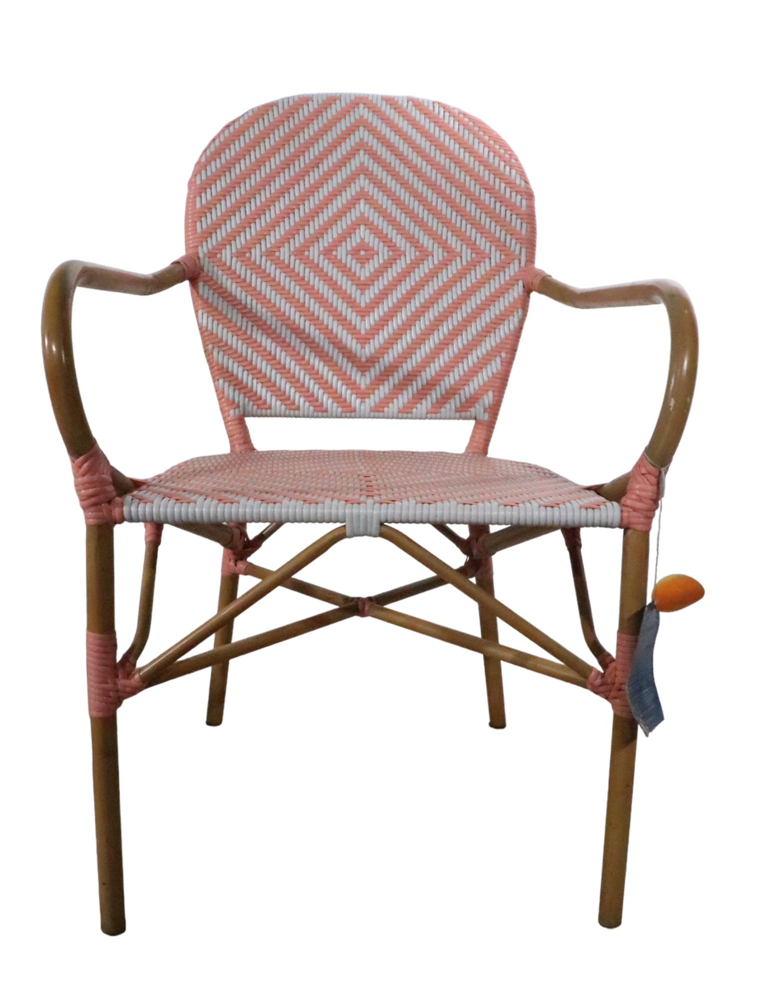 Pr. charming French Bistro, Cafe style arm chairs, one in pink, one in blue. The chairs have metal faux bamboo frames, with woven seats and back rests. Both are in very good original, clean and ready to use condition. Made in China, Imported for