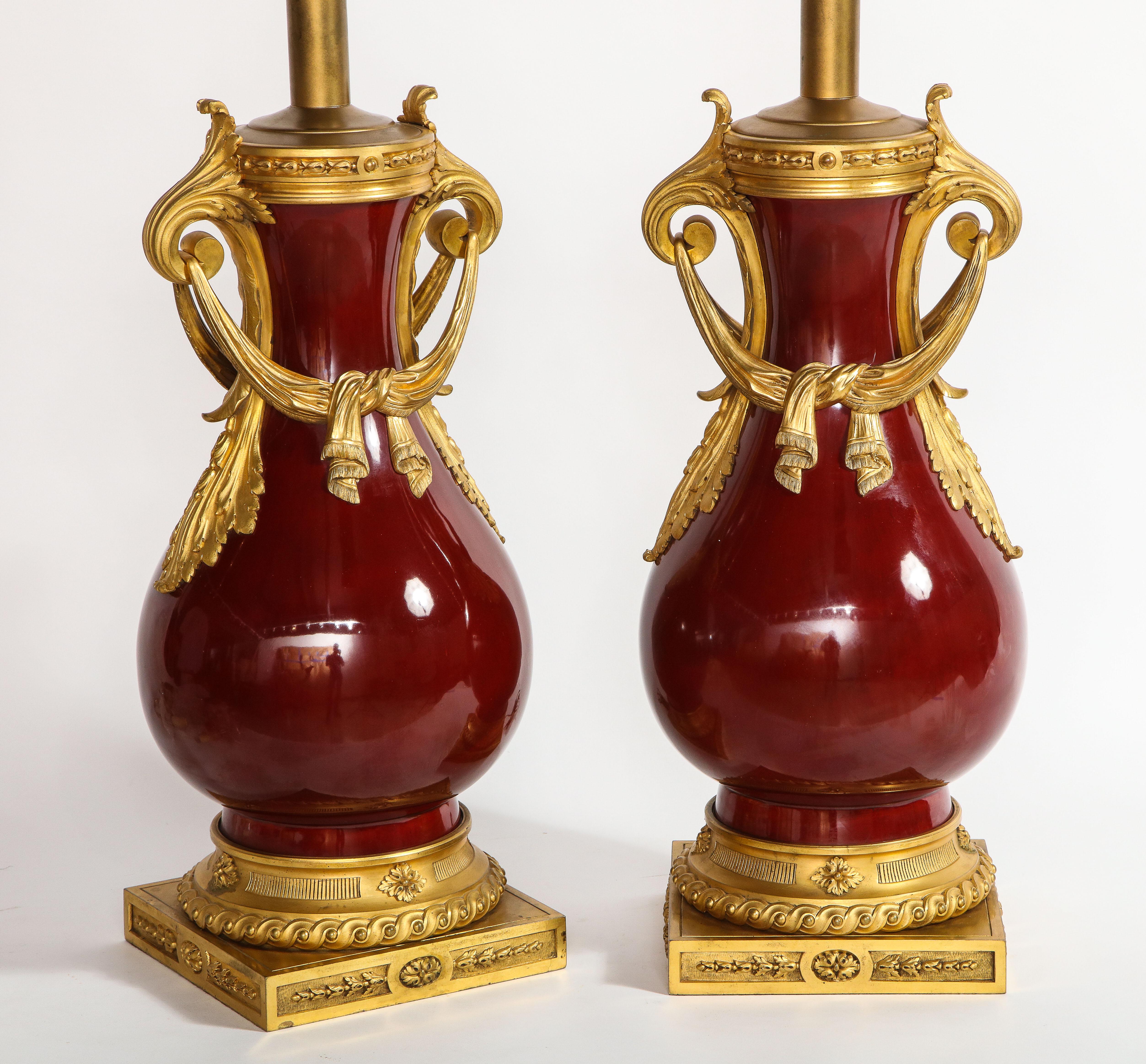 Gilt French Louis XVI Style Dore Bronze & Chinese Sang De Boeuf Porcelain Lamps, Pair For Sale