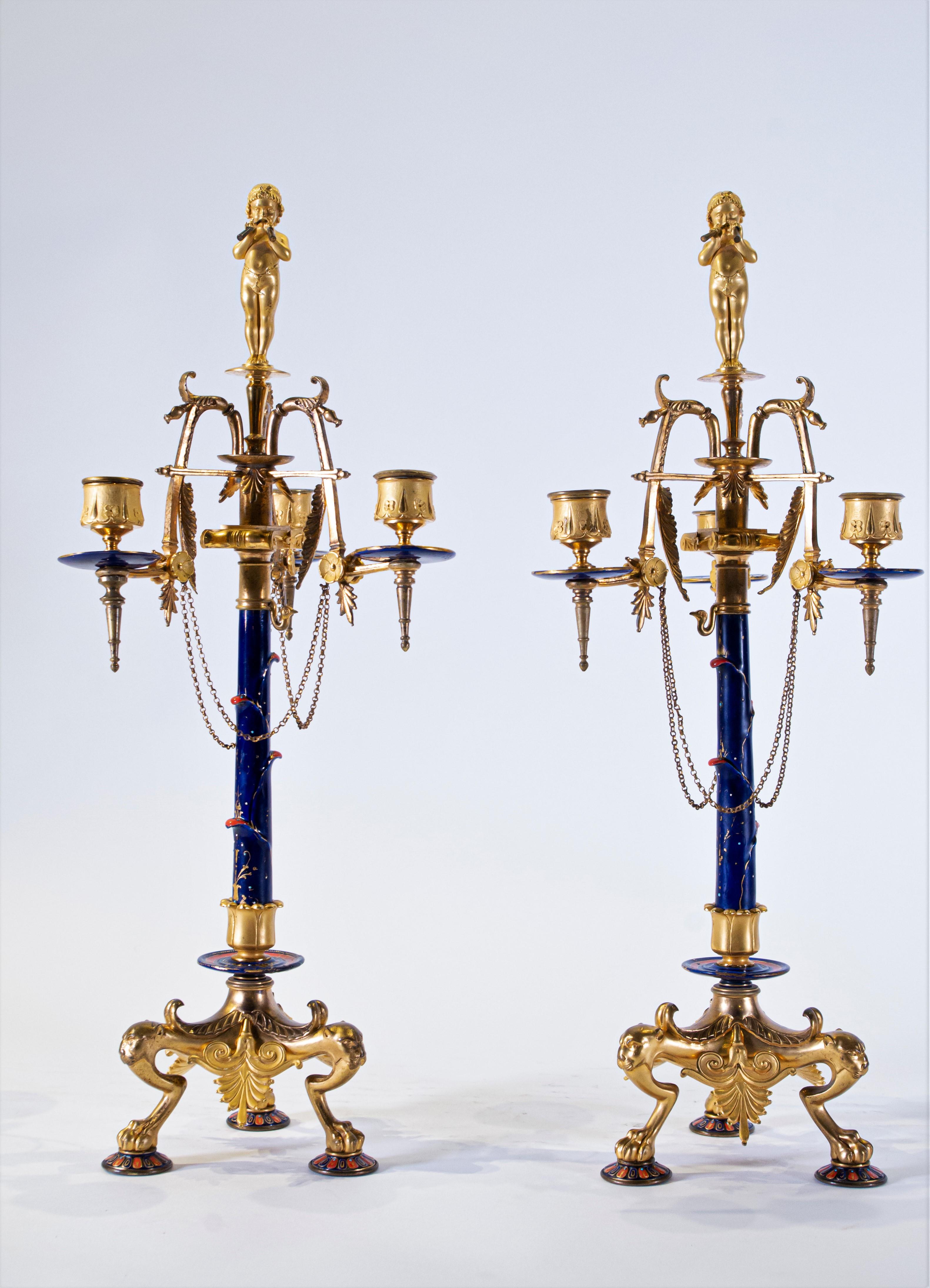 A gorgeous and highly unique pair of 19th century French Neo-Grec style three-arm doré bronze and enamel candelabras, Attributed to Ferdinand Levillain, Stamped L C. Each candelabra is beautifully cast, hand-chassed and hand-chiseled with