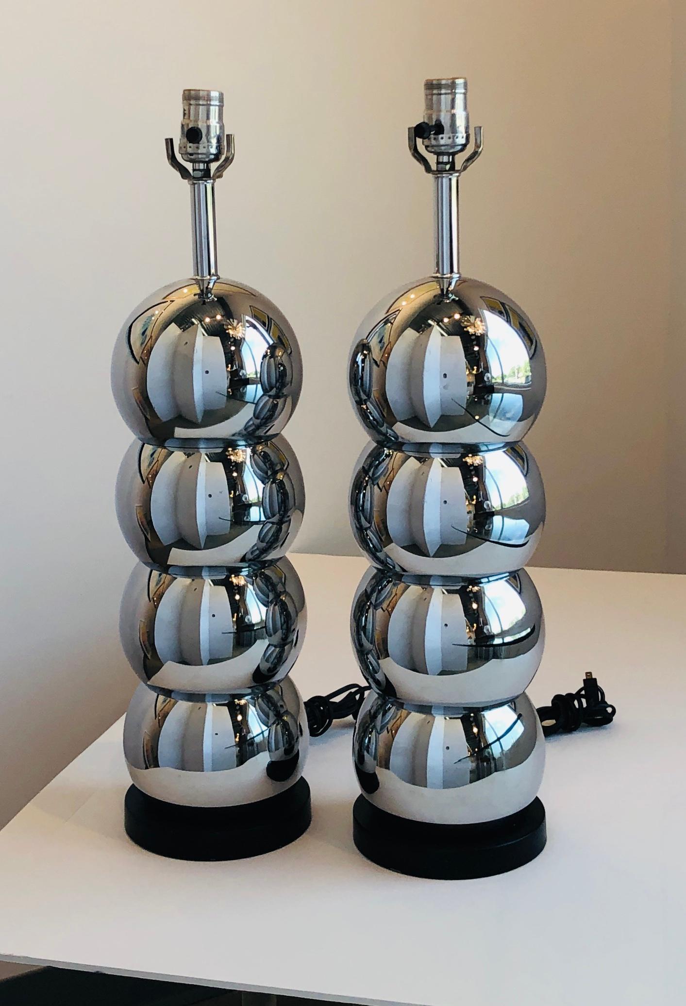 Offered is a pair of Mid-Century Modern stacking chrome plated ball and black wood base table lamps by George Kovaks. We have added the Lucite base, Lucite finial and black shades (shades and bulbs are not included.) This George Kovacs design was