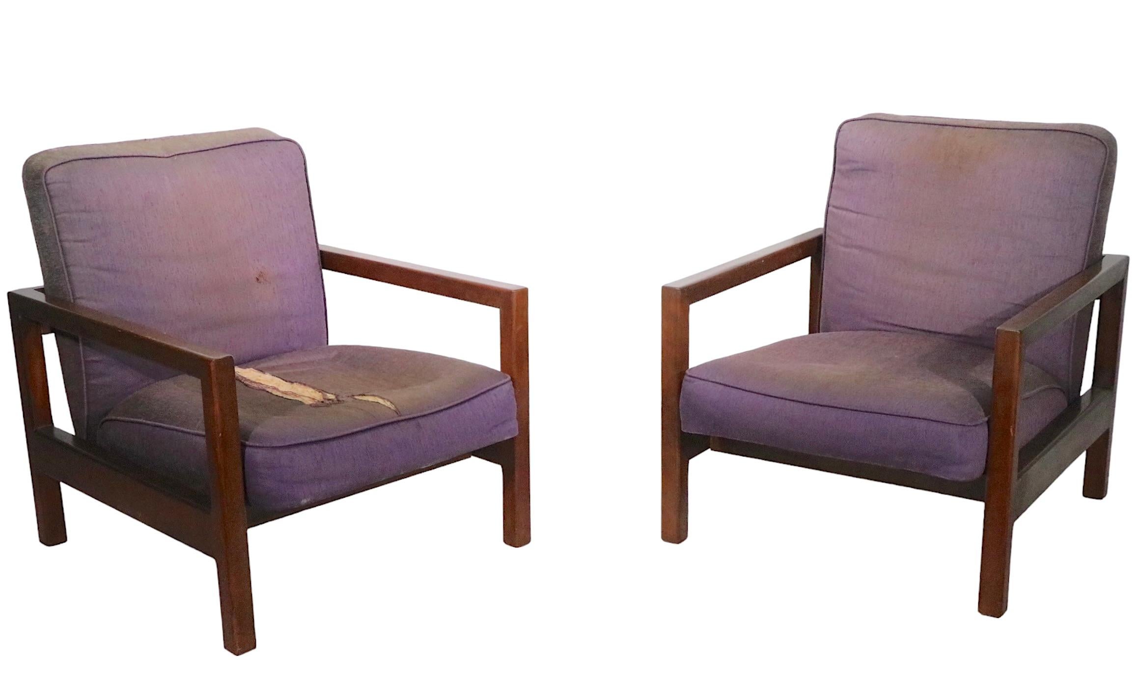 Sophisticated, chic, voguish pair of lounge chairs designed by George Nelson for Herman Miller circa 1950s. The chairs feature solid maple frames with thick upholstered seats and backs, the upholstery is as is and will need to be replaced, please