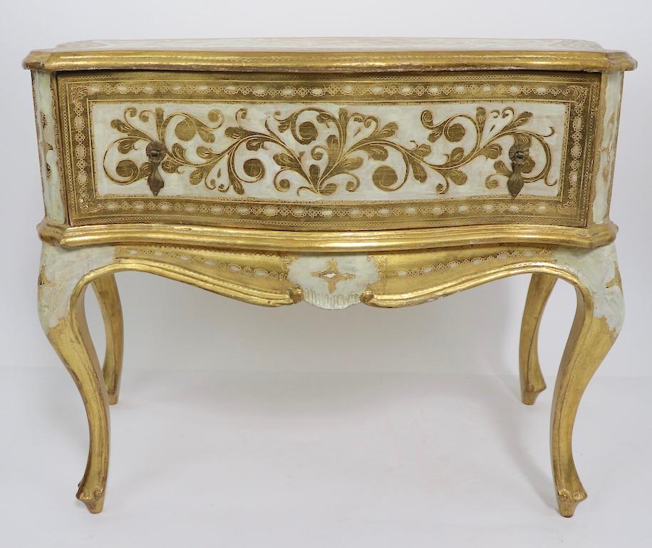 Stunning pair of giltwood one drawer night tables Made in Italy by Florentine Furniture. The tables feature a off white ground with gilt foliate design, Both tables are in very good, original untouched condition, clean and ready to use. Originally