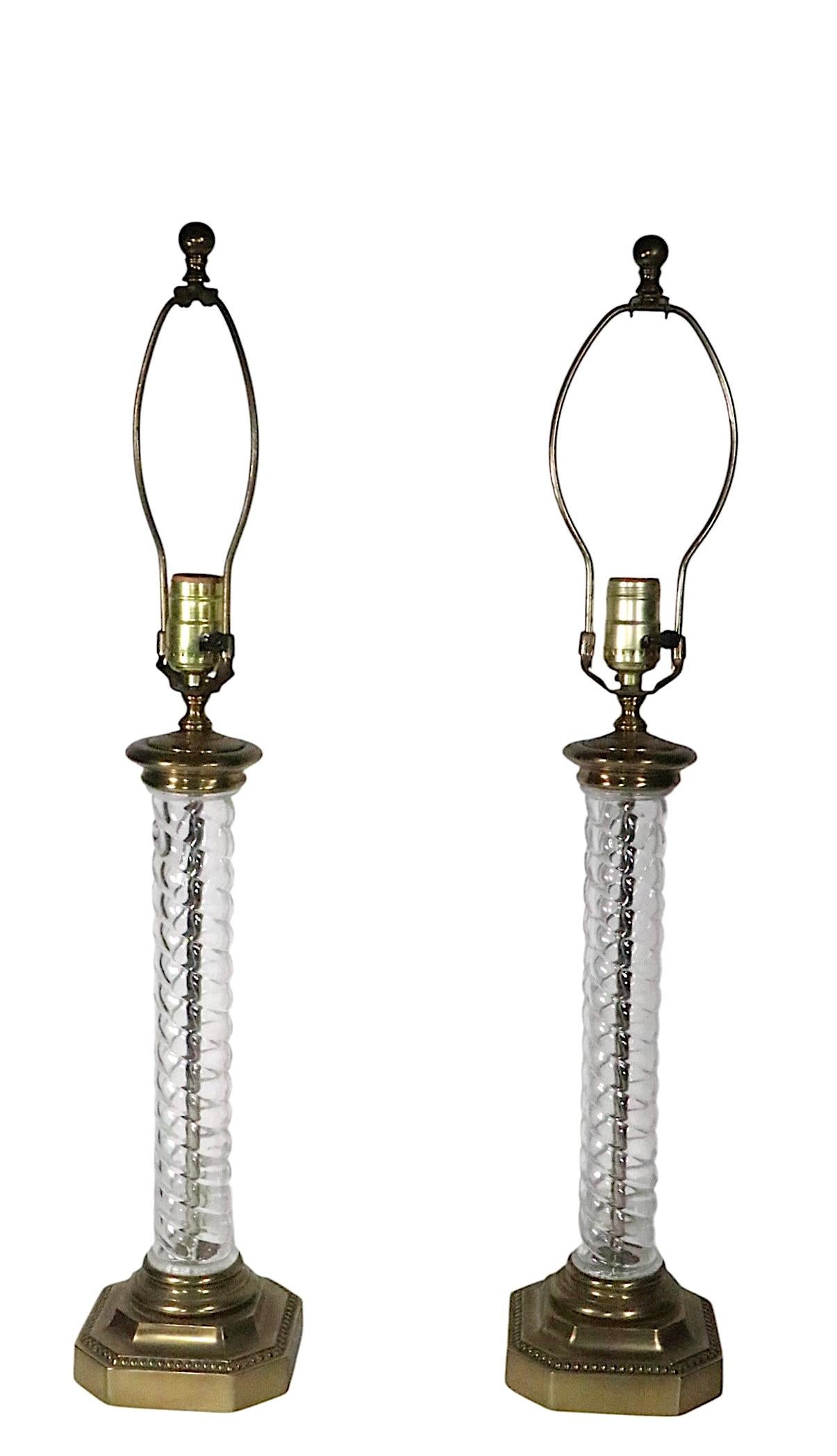 Pair of Hollywood Regency, Neo Classical, Art Deco style table lamps, by Paul Hanson, circa 1950/70's. The lamps feature twisted glass columns, mounted on metal bases. Both lamps are in very fine, original clean, working and ready to use condition.
